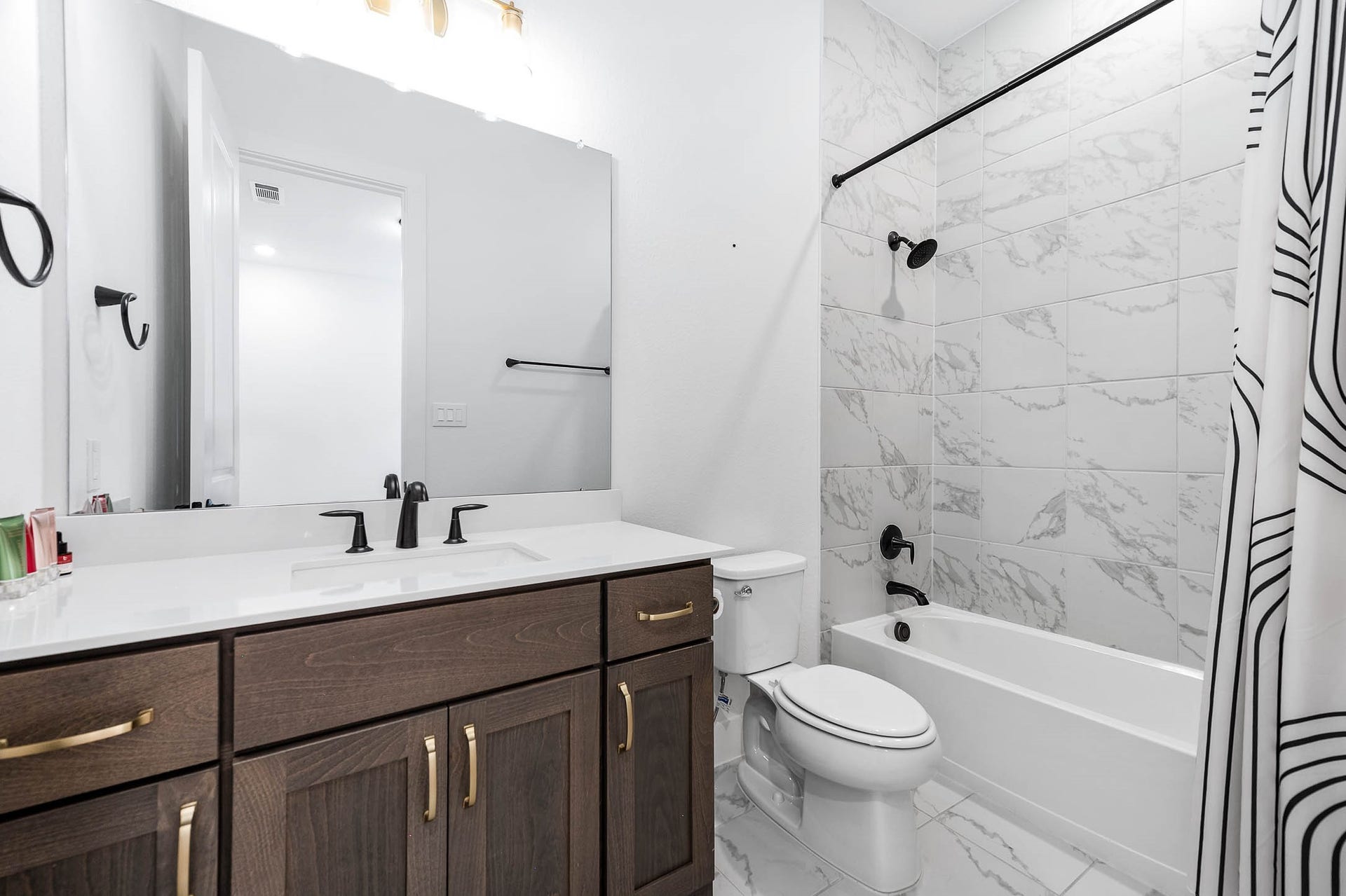 13802 Arroyo Grande Drive, Cypress, TX 77433 Secondary bathroom featuring a tub and shower combination with modern finishes.