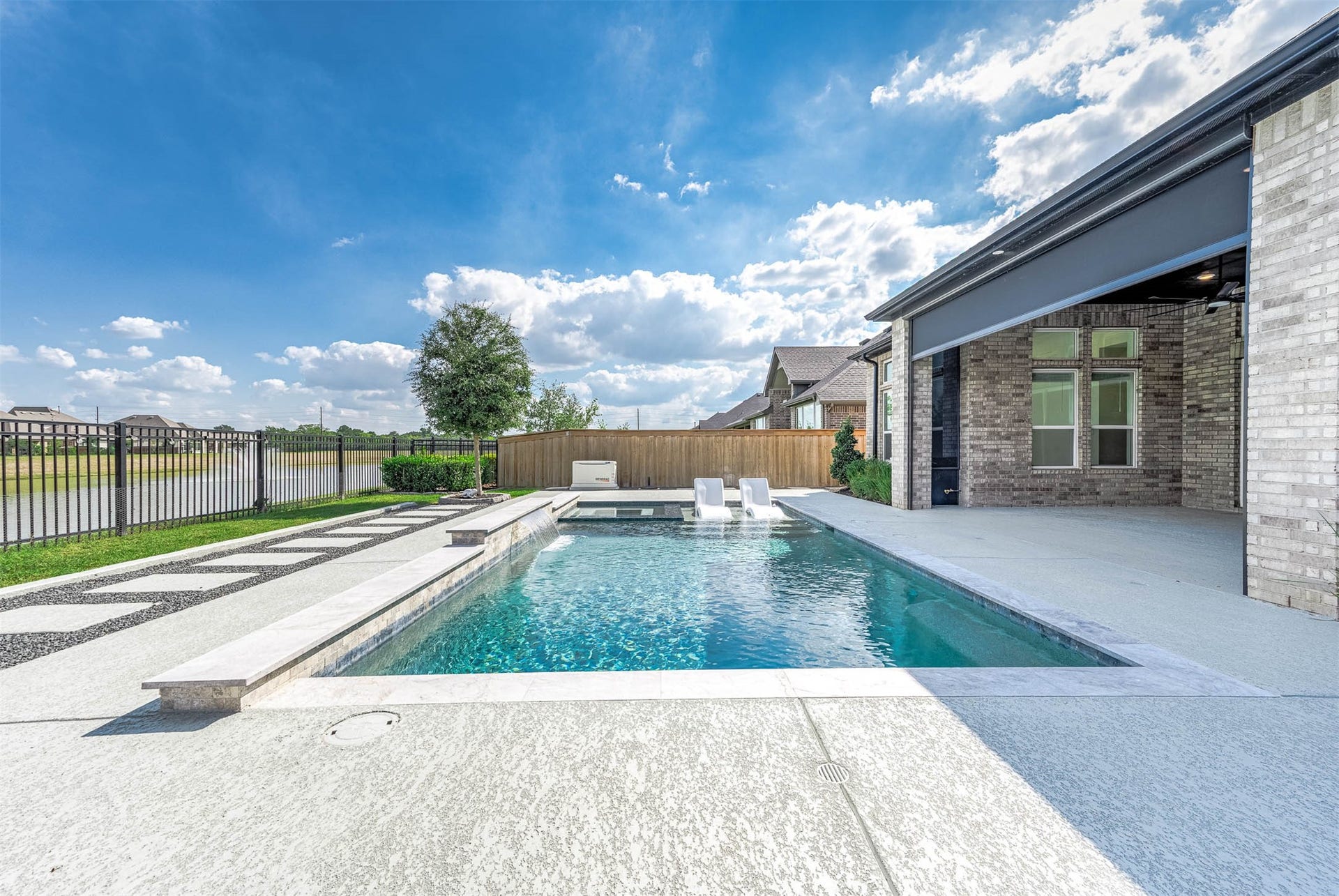 13802 Arroyo Grande Drive, Cypress, TX 77433 Stunning pool and spa surrounded by professionally maintained landscaping.
