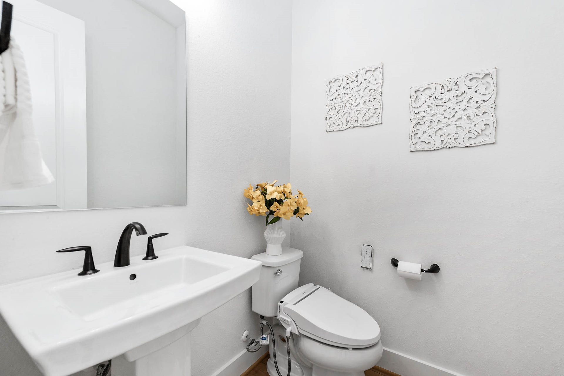 13802 Arroyo Grande Drive, Cypress, TX 77433 Convenient powder bathroom with modern finishes and a pedestal sink.