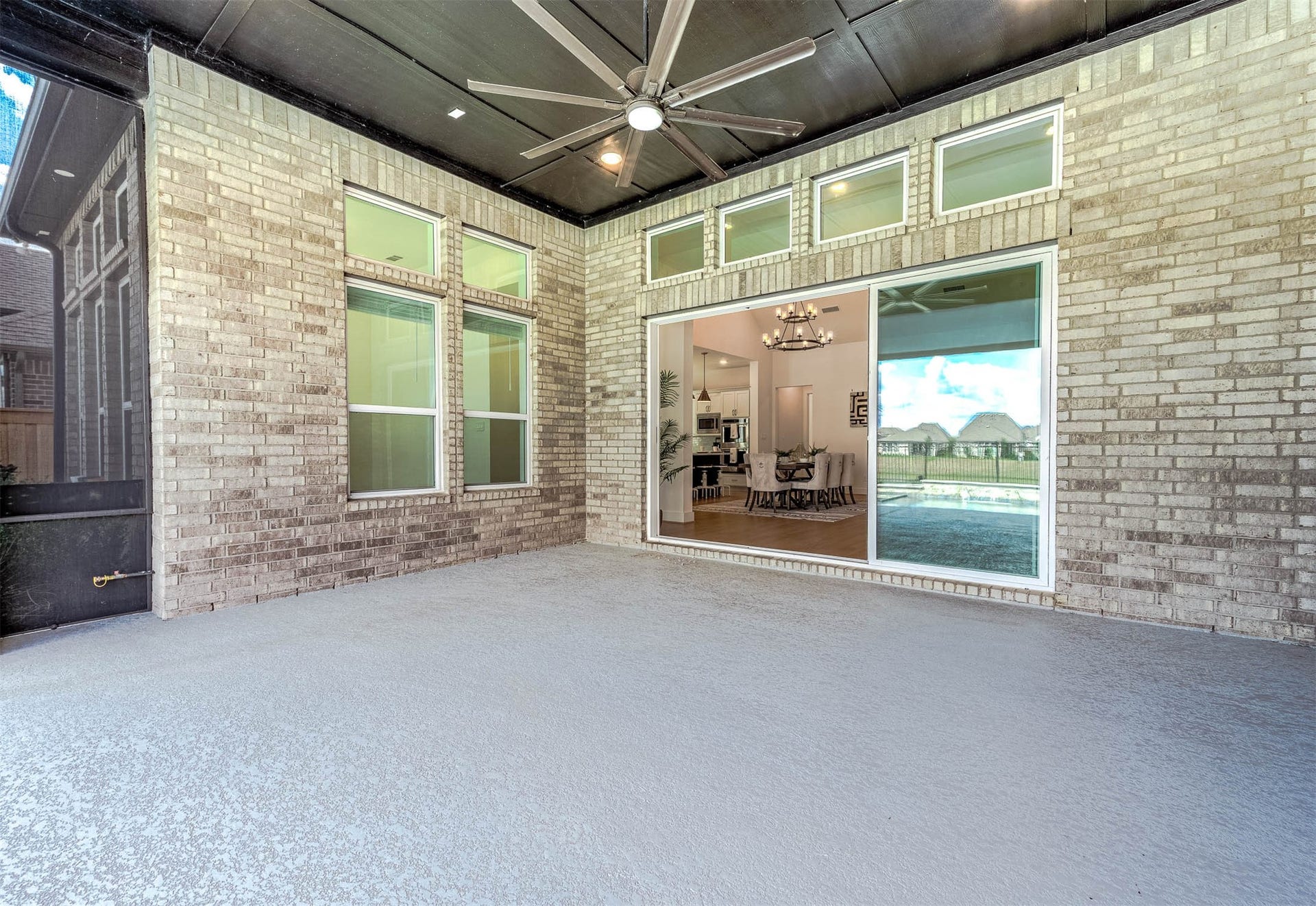 13802 Arroyo Grande Drive, Cypress, TX 77433 Expansive 30-foot covered patio featuring retractable power screens and a natural gas connection for a future outdoor kitchen.