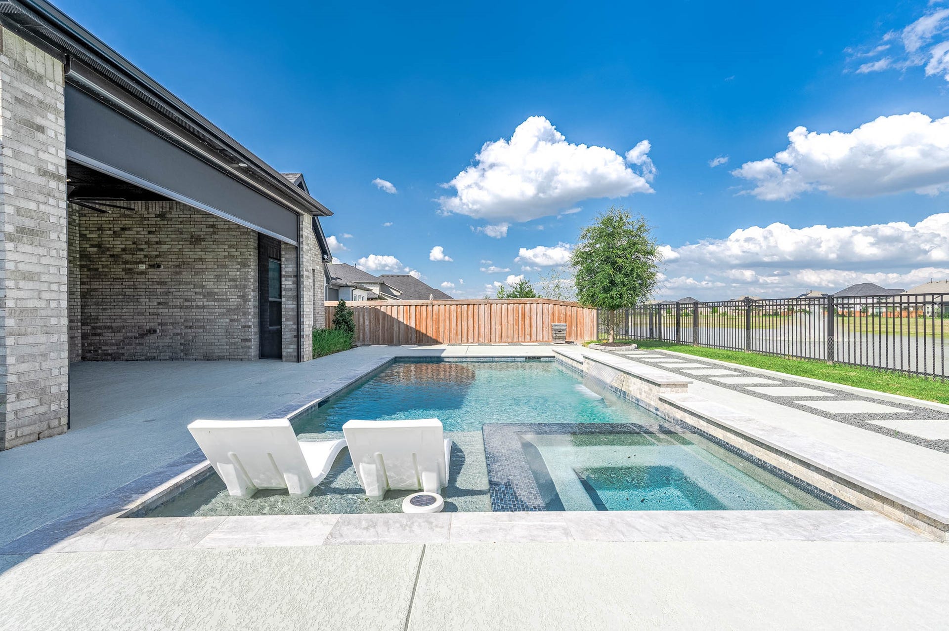13802 Arroyo Grande Drive, Cypress, TX 77433 Resort-style backyard featuring a sparkling pool, spa, and scenic views.