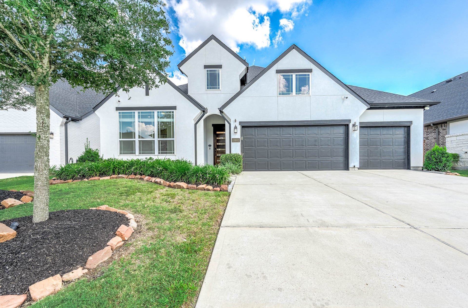 13802 Arroyo Grande Drive, Cypress, TX 77433 Beautiful front elevation showcasing the home's attractive architecture and three-car garage.