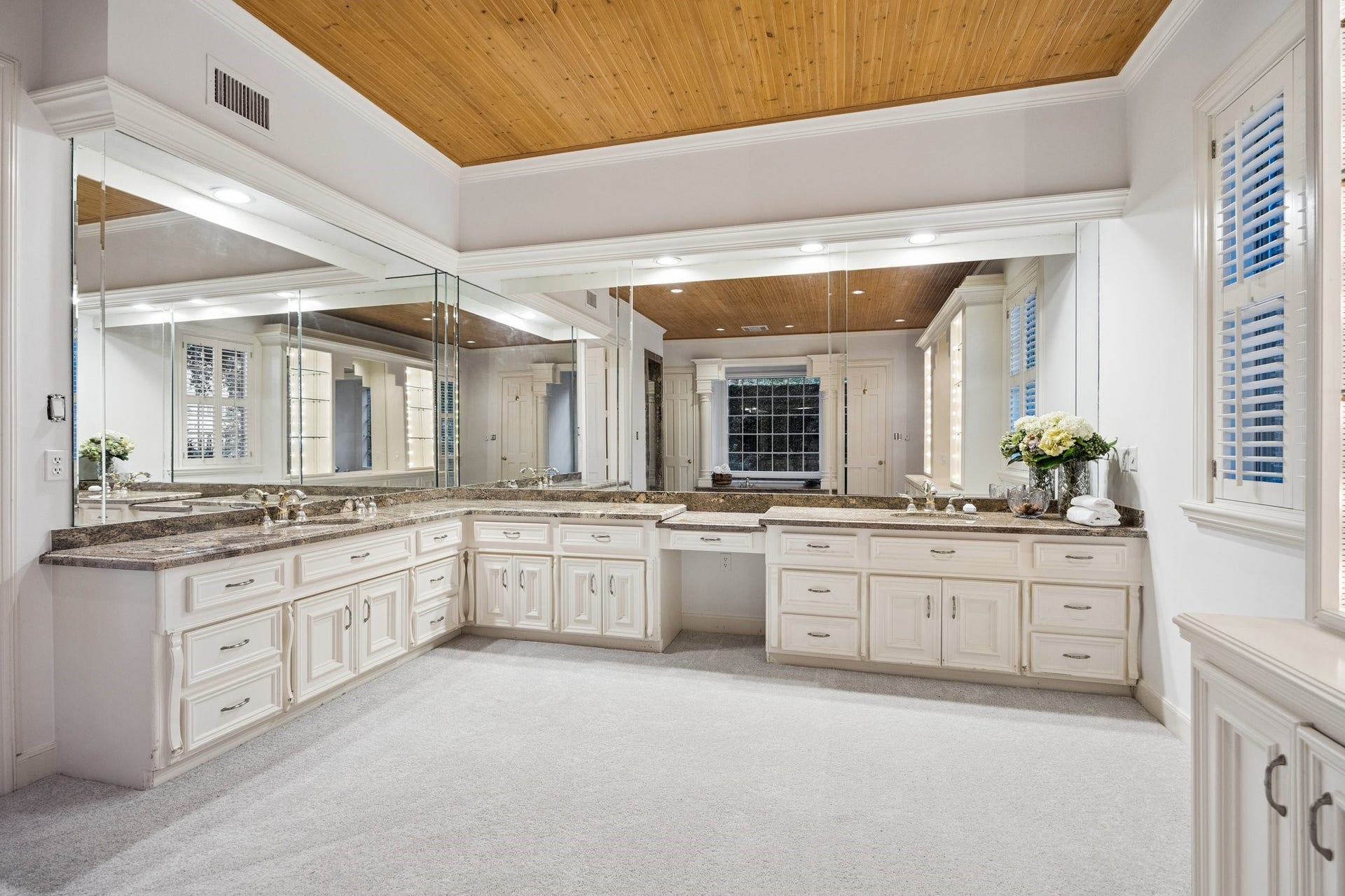 10 Stillforest Street, Piney Point Village, TX 77024 The private bath is completed by a spacious glass-and-granite shower and dual water closets, offering a serene and sophisticated retreat.