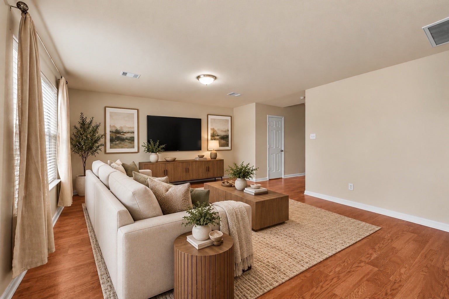 4035 Pedernales River Lane, Spring, TX 77386 Virtually staged photo. Spacious living area with an open layout, warm wood-look flooring, and plenty of natural light. This image has been virtually staged to help showcase the rooms size, layout, and potential for furniture placement. Furnishings and dcor shown are not included with the property.
