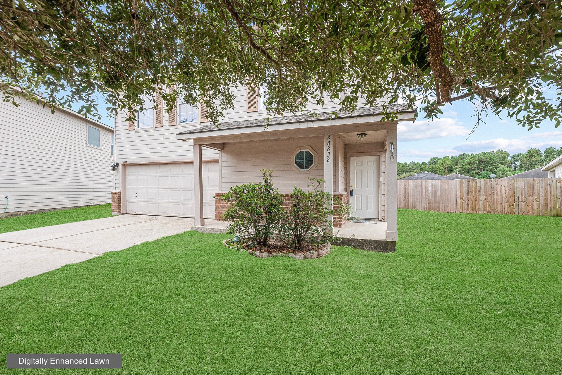 28838 Frio River Loop, Spring, TX 77386 A mature tree frames the covered front porch and brick-accented exterior.