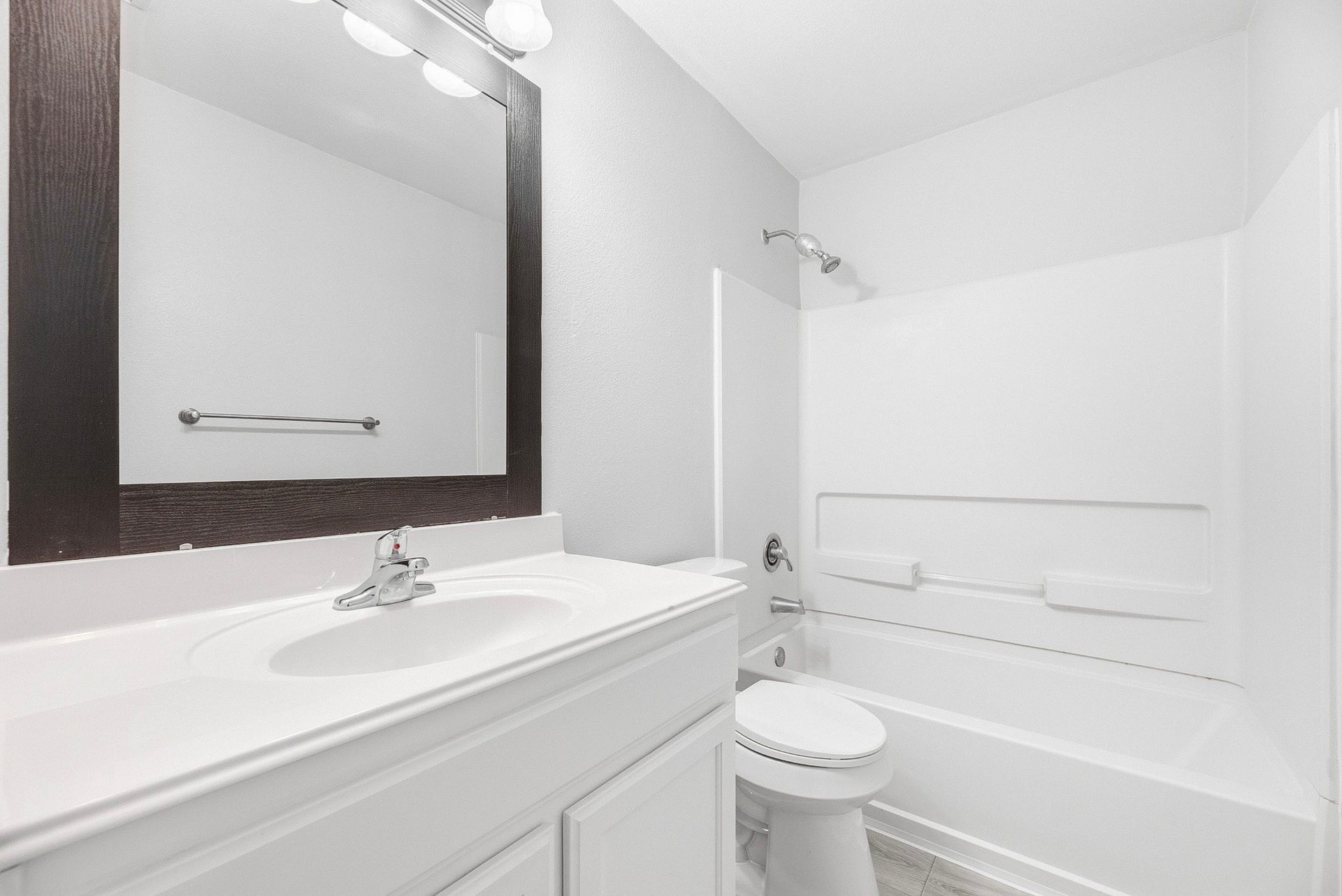 28838 Frio River Loop, Spring, TX 77386 Bathroom offers a white vanity, framed mirror, and a tub with shower surround.