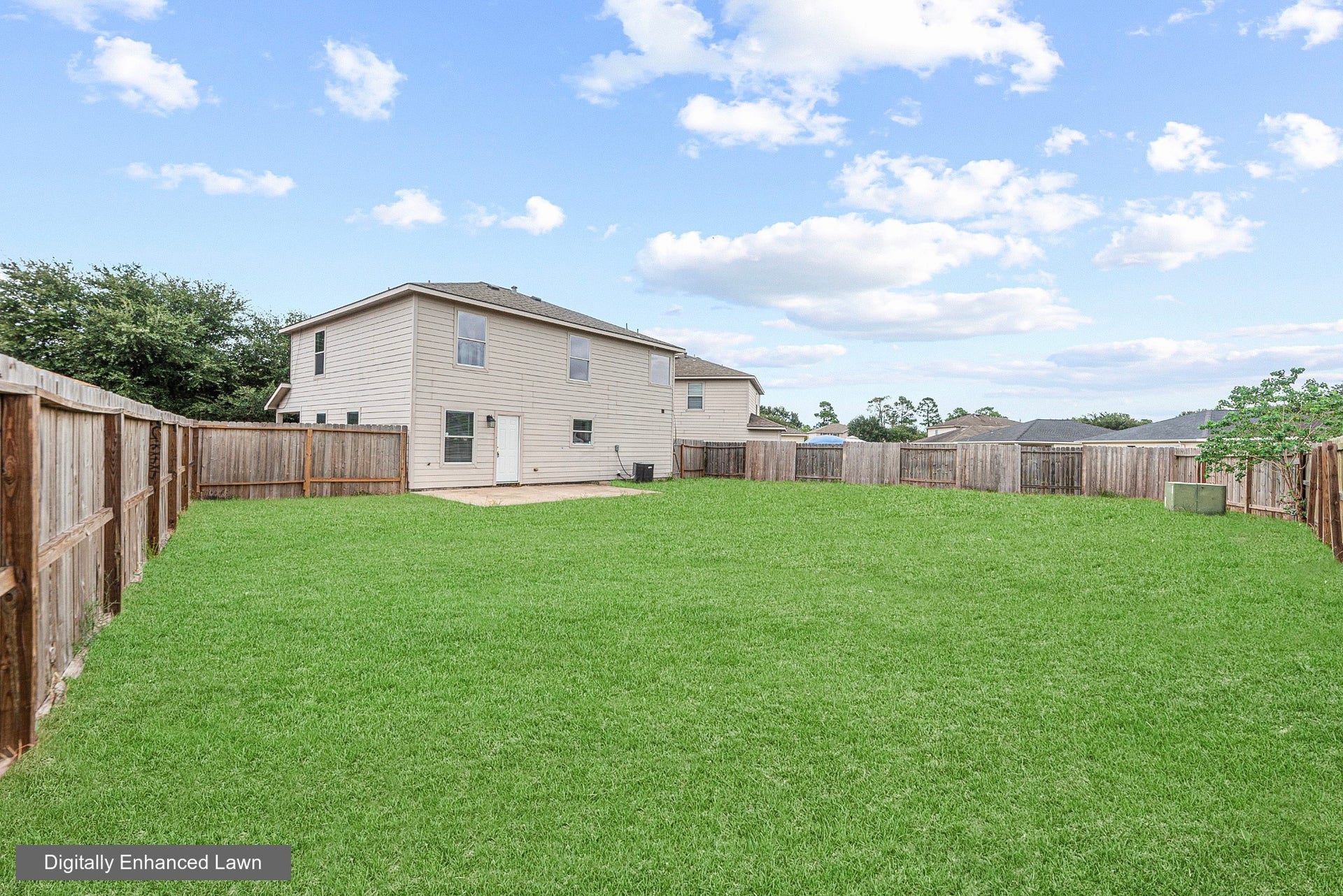 28838 Frio River Loop, Spring, TX 77386 Wood fencing encloses the backyard, with the home and concrete patio along one side.