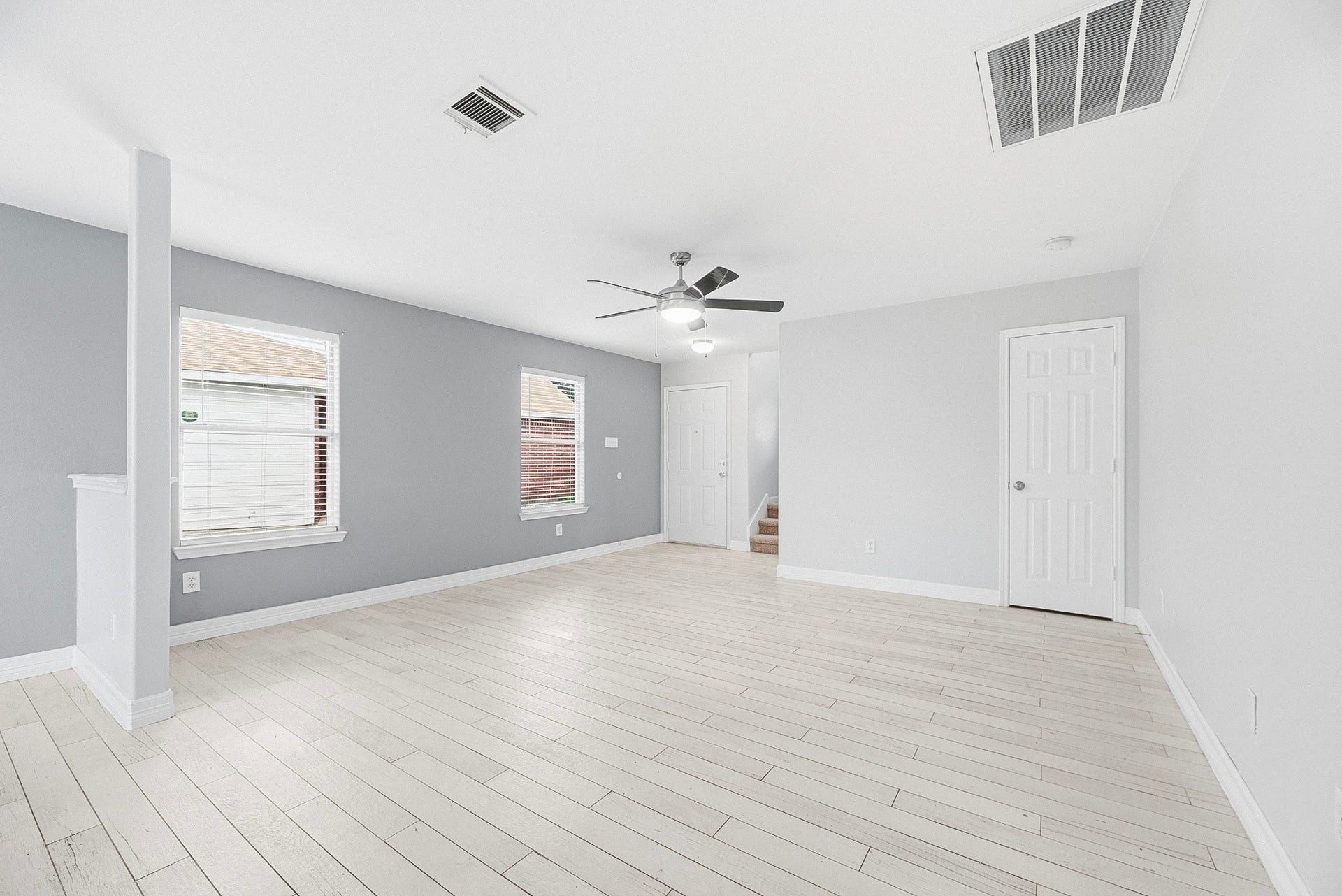 28838 Frio River Loop, Spring, TX 77386 Living room windows bring natural light to the open space beside the staircase and entry.