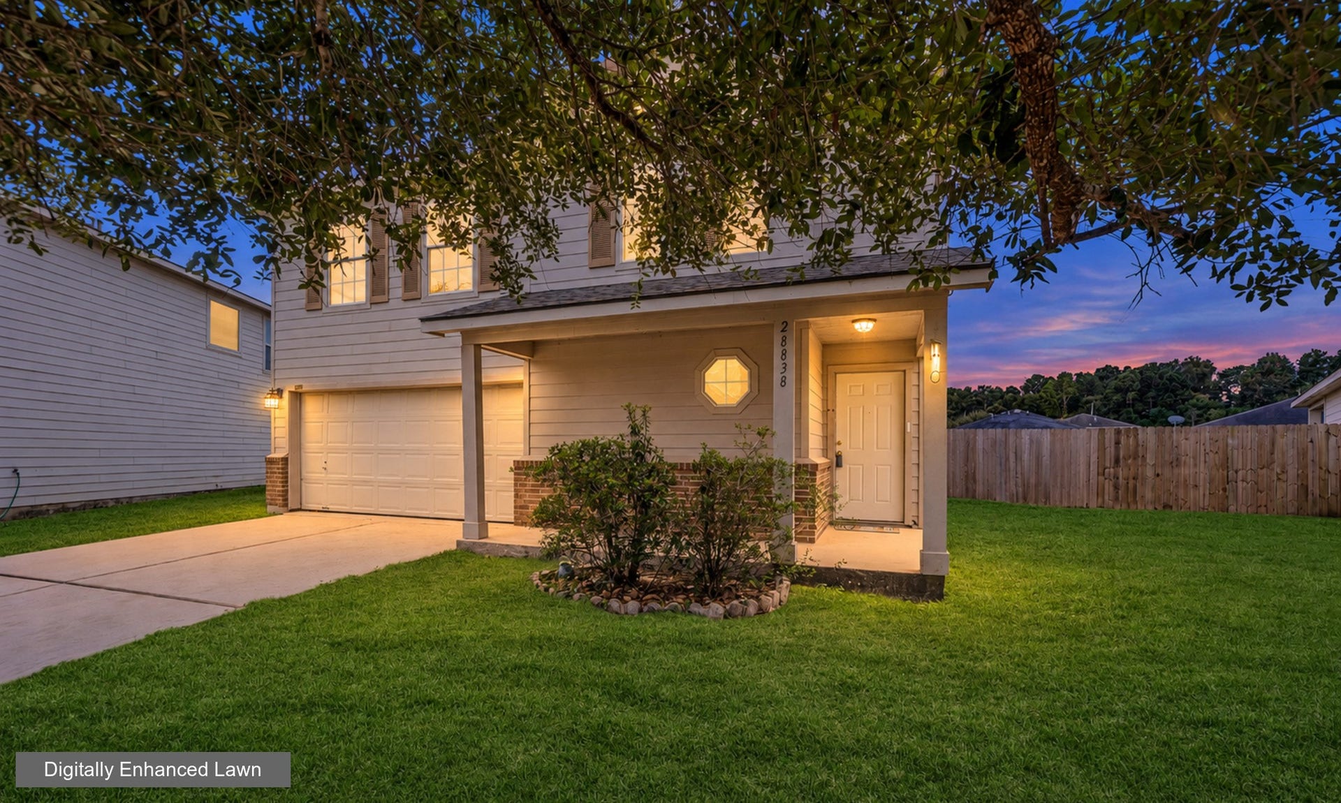 28838 Frio River Loop, Spring, TX 77386 Twilight enhancement showcases the covered porch, brick accents, and distinctive octagonal window.