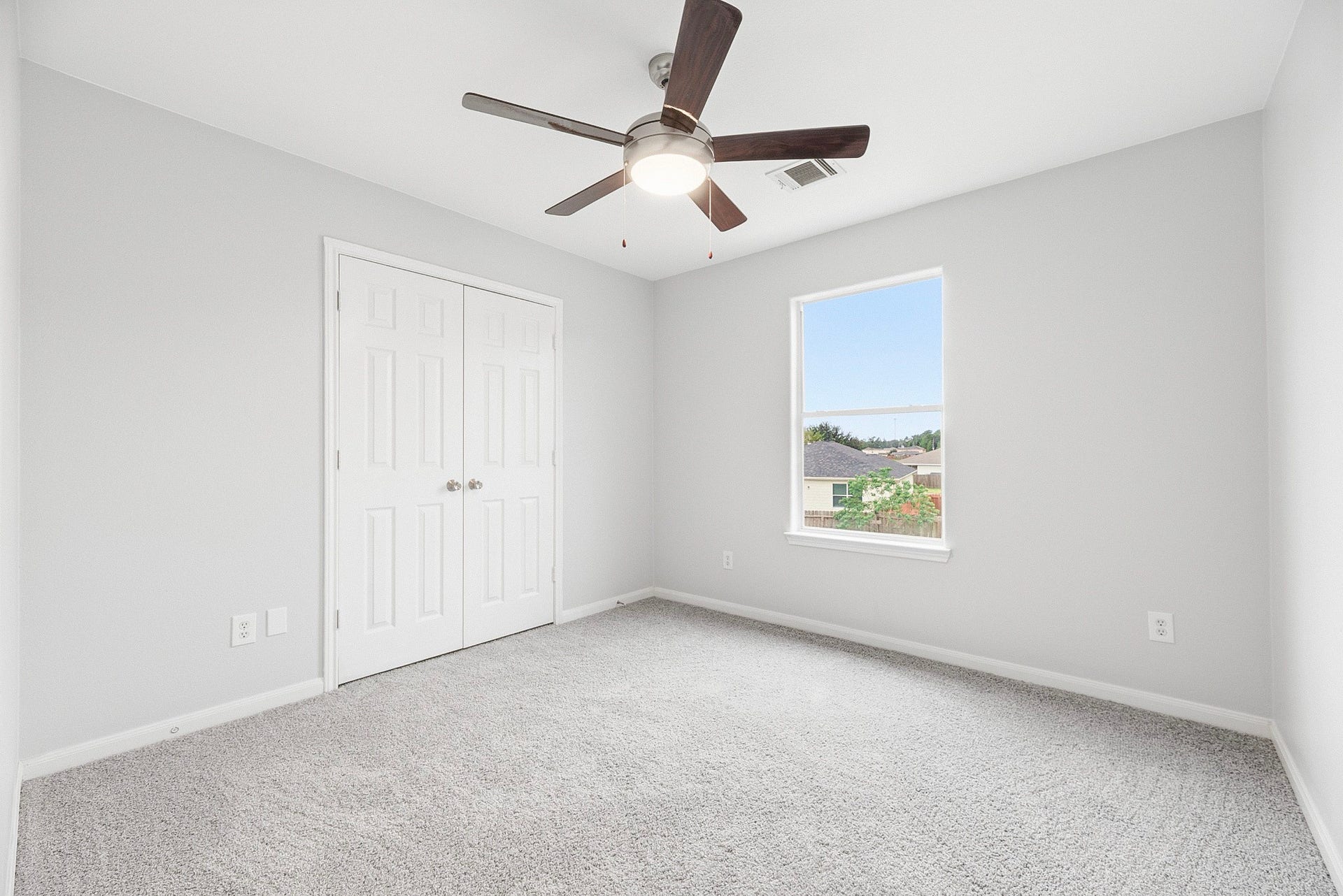 28838 Frio River Loop, Spring, TX 77386 Carpeted bedroom includes a ceiling fan, natural light, and double closet doors.