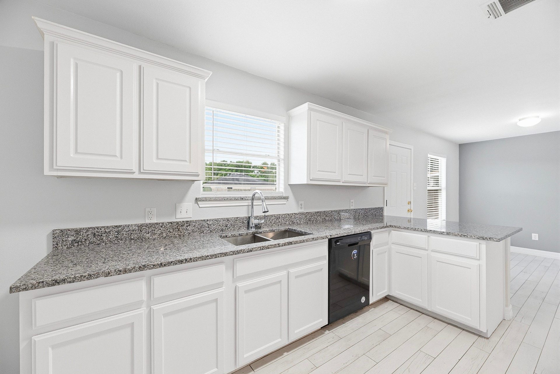 28838 Frio River Loop, Spring, TX 77386 A window above the sink adds daylight to the kitchens counter space and peninsula.