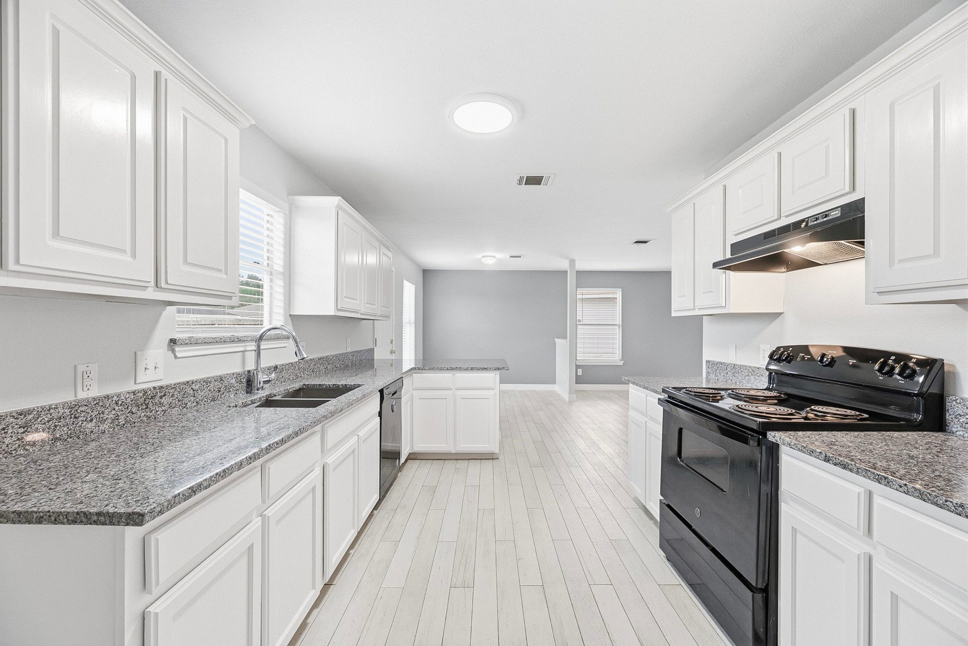 28838 Frio River Loop, Spring, TX 77386 Kitchen sightlines extend toward the breakfast area, with cabinets and counters along both sides.