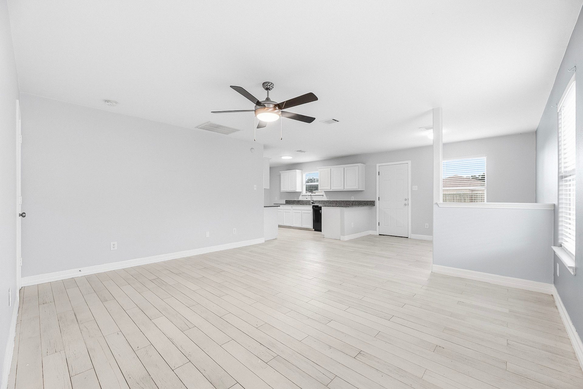 28838 Frio River Loop, Spring, TX 77386 Light wood-look flooring connects the living room, kitchen, and adjacent breakfast area.