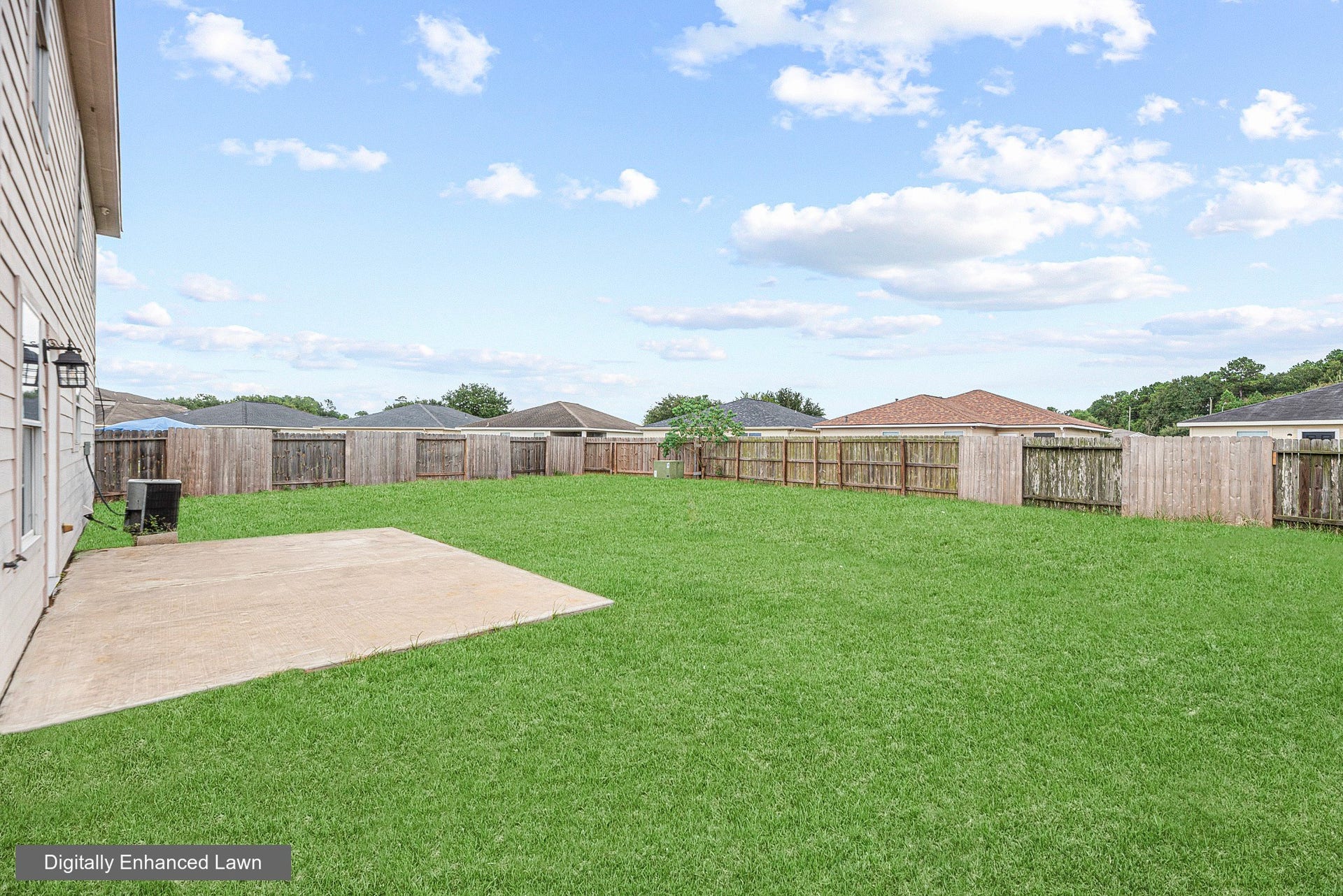 28838 Frio River Loop, Spring, TX 77386 Concrete patio opens to a fenced backyard with broad lawn space and open sky.
