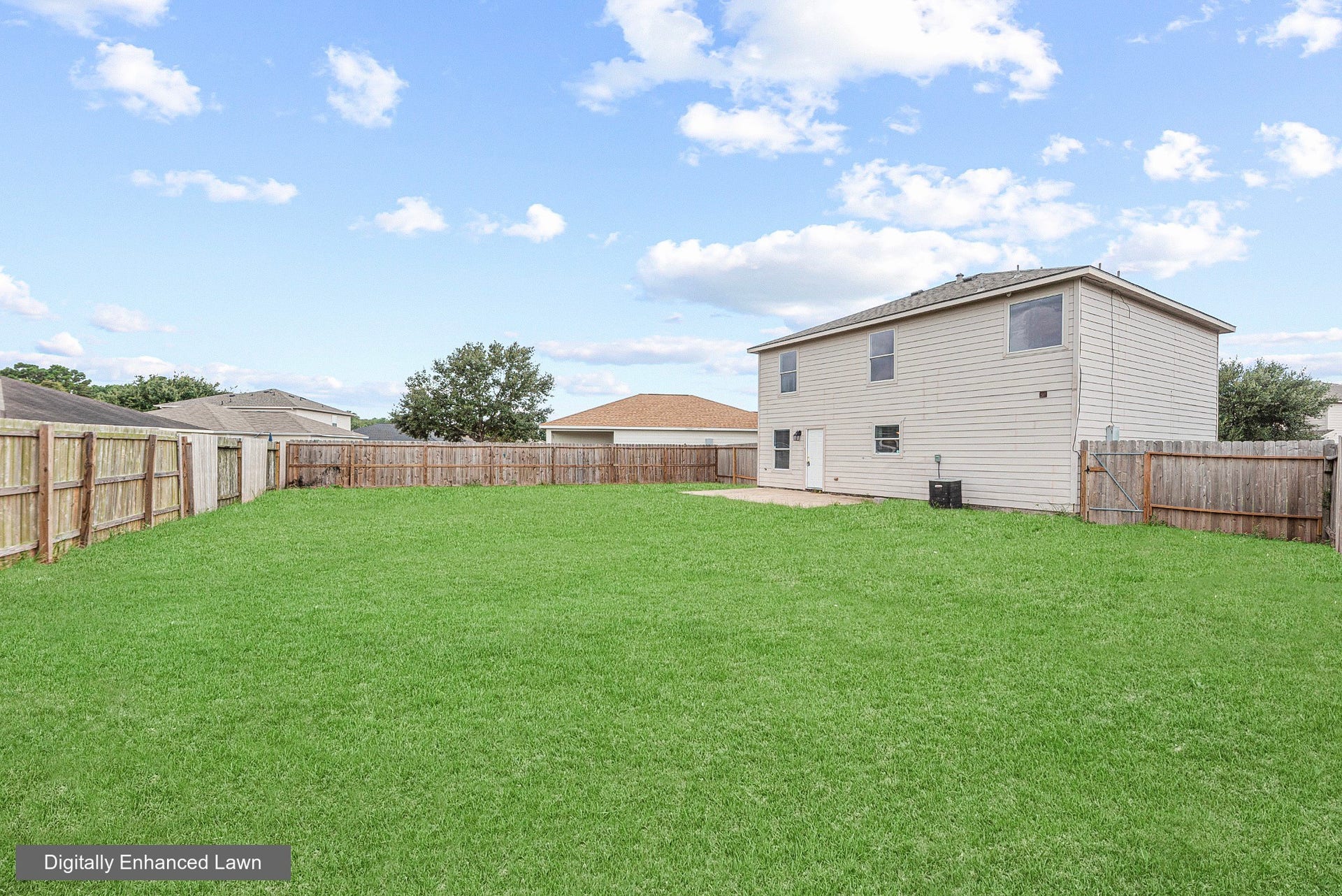 28838 Frio River Loop, Spring, TX 77386 Rear exterior overlooks the fenced backyard, with a concrete patio just outside the back door.