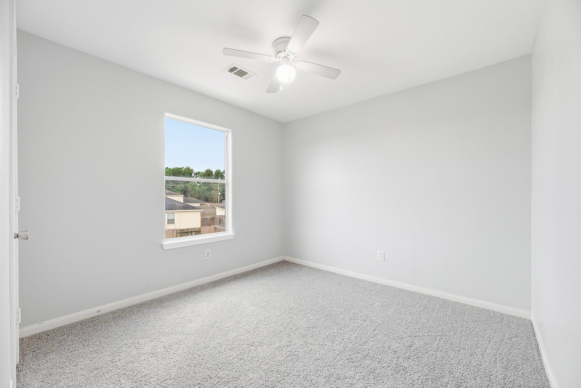 28838 Frio River Loop, Spring, TX 77386 A window and ceiling fan complement this bedrooms neutral walls and carpeting.
