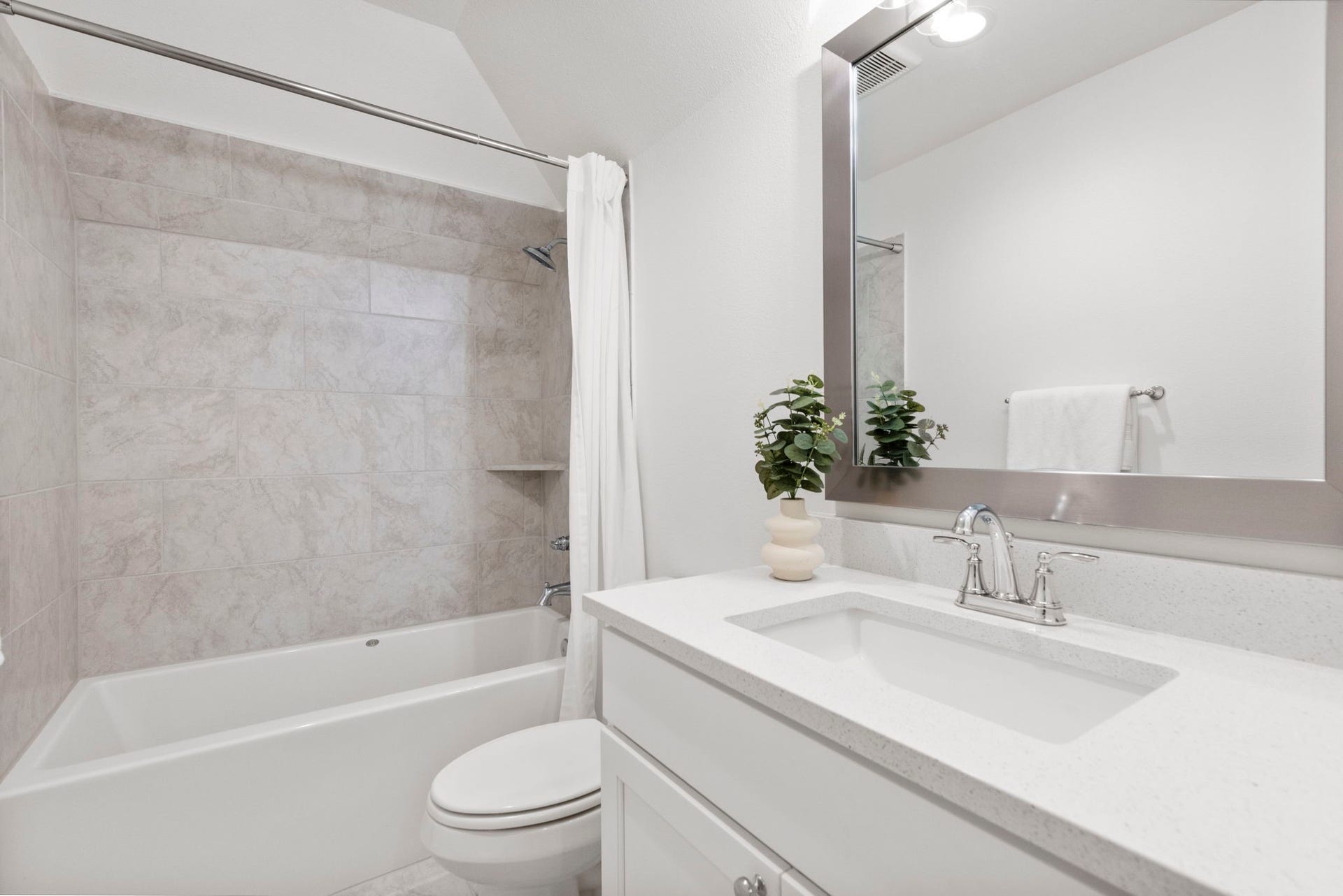 Bathroom three is crisp and fresh looking and has a tub/shower combo.