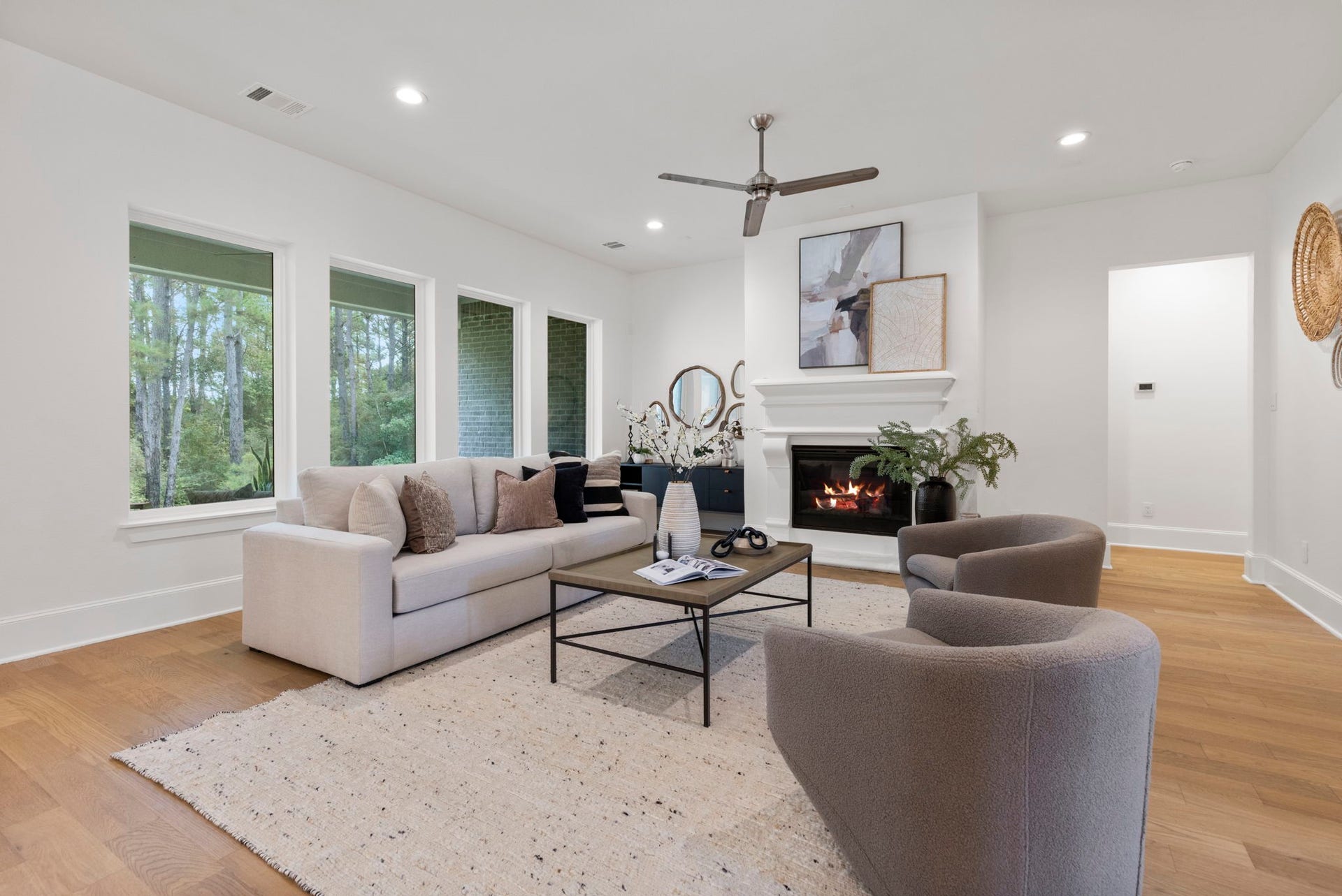 The family room is bright and spacious, featuring a stunning wall of windows that offers beautiful views of the natural scenery.