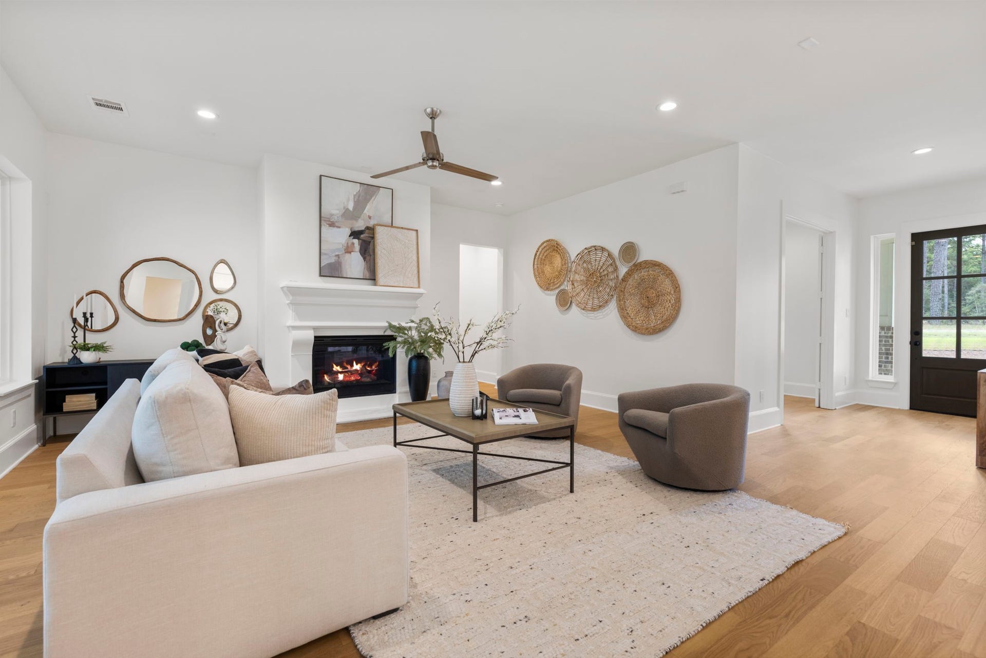 This upscale, inviting living area features a relaxing ambiance centered around a fireplace with an elegant mantle. To the left, a recessed niche provides the perfect space-saving nook to showcase a gorgeous piece of furniture or decor.