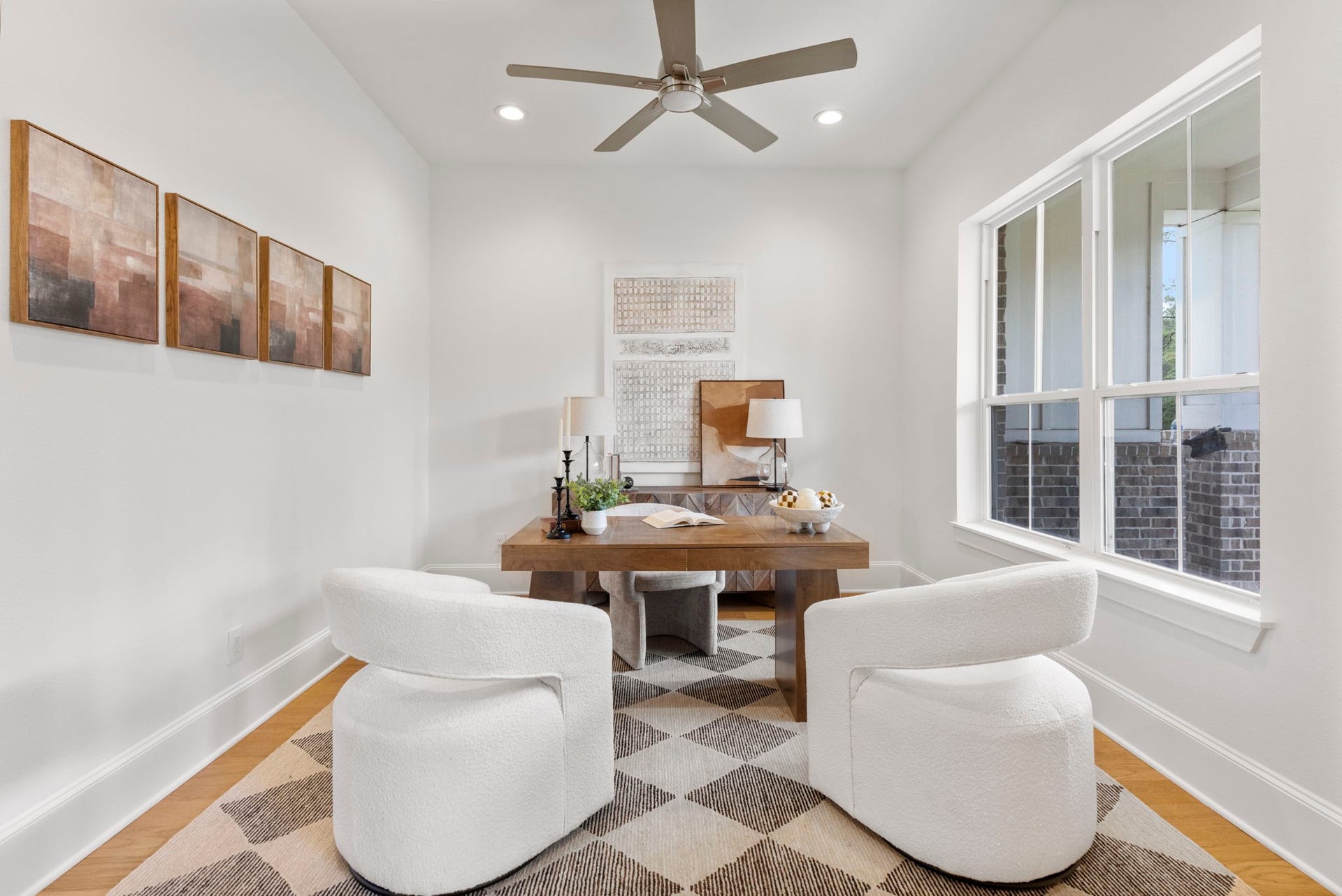 This home office features private double doors and offers stunning, panoramic views of the expansive front yard and its mature, majestic trees. This could also be used as a dining room.