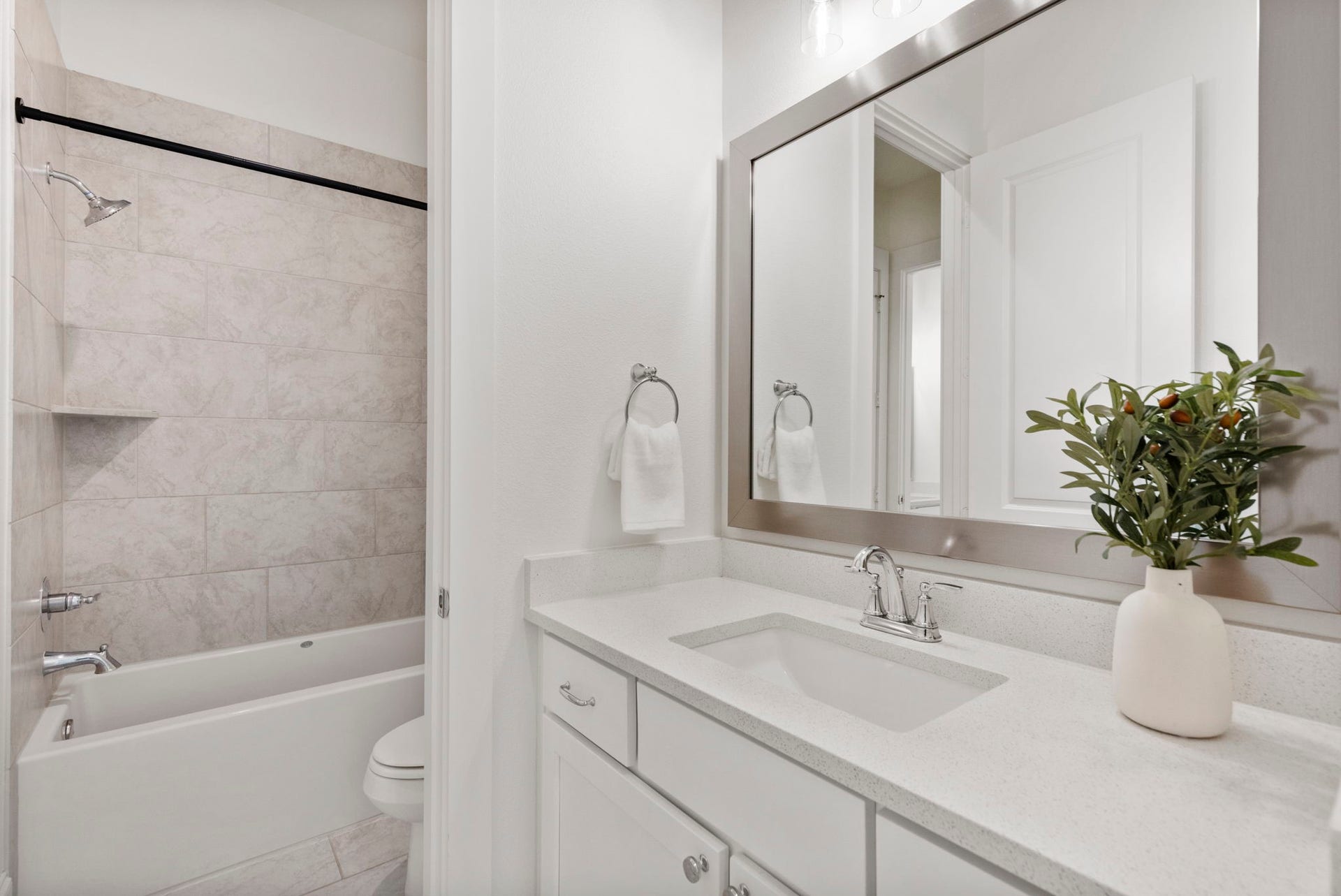 Bathroom two is light and bright with modern vanity and a tub/shower combo.