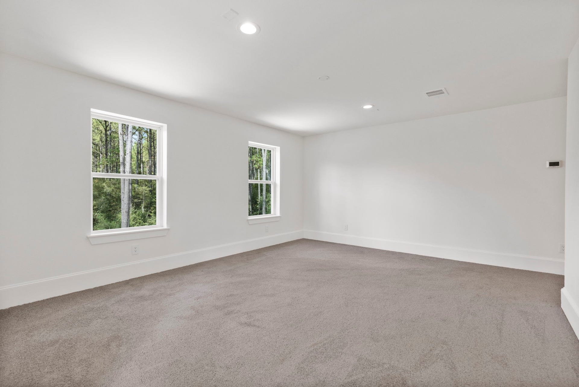 This expansive game room offers ample space for both lounge furniture and multiple game tables.