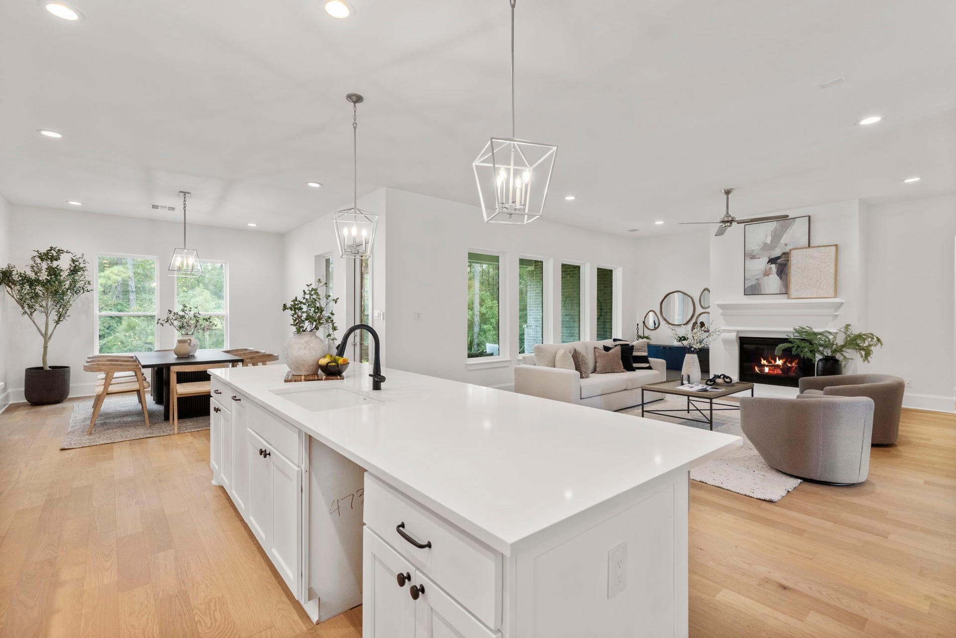 Spectacular open-concept living space featuring a seamless transition from the kitchen to the dining and family rooms, perfect for modern entertaining.