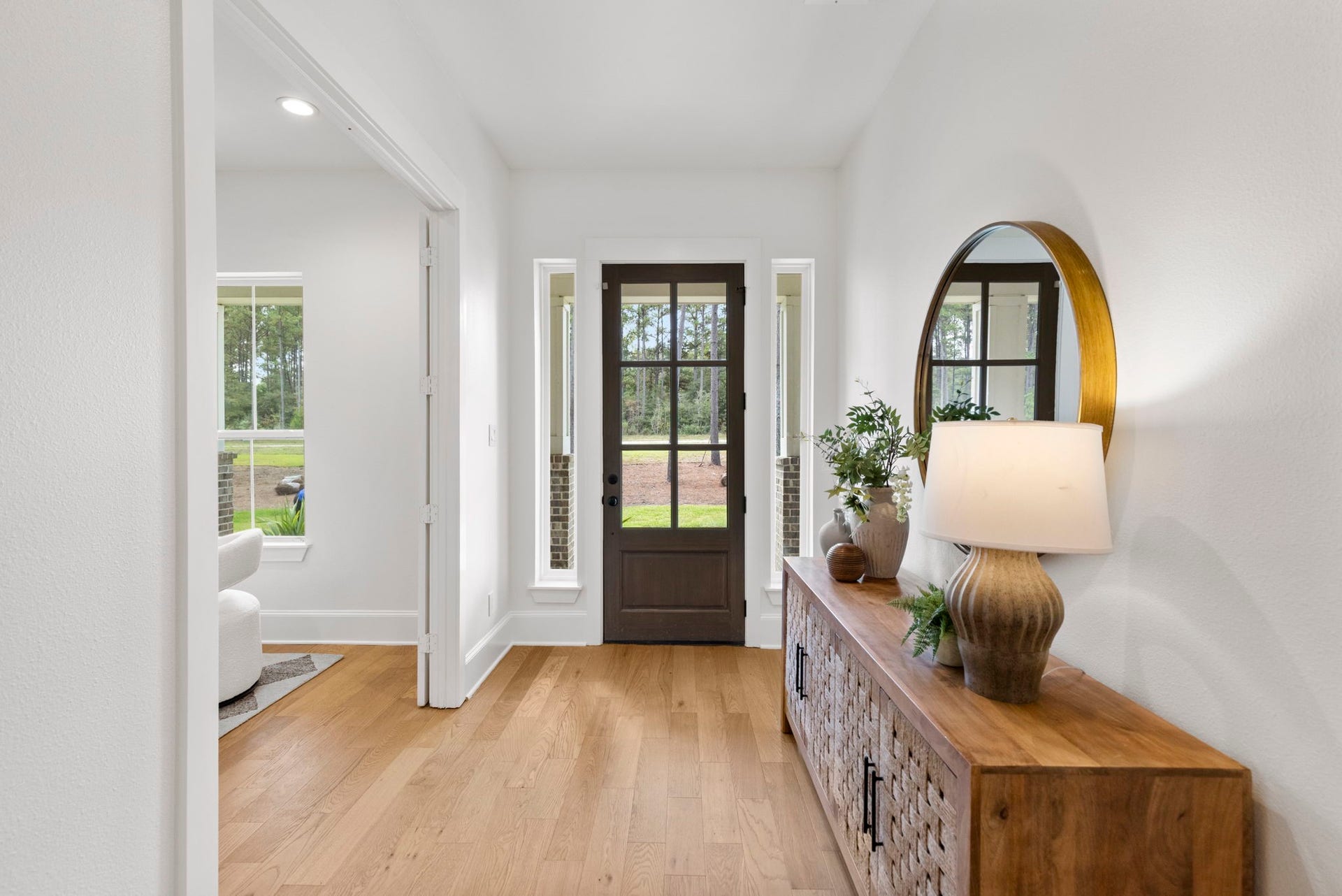 This gorgeous entry features sophisticated engineered wood flooring complemented by crisp, designer-white walls for an inviting and elegant first impression.