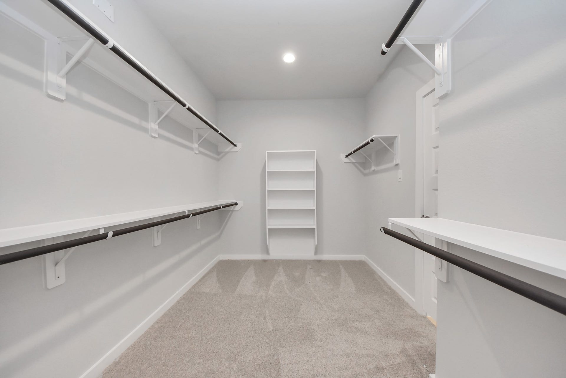 15111 Statice Trail, Houston, TX 77044 Walk-in closet that epitomizes luxury and practicality. This generously sized space features built-in shelving, offering abundant room for impeccable organization. High ceilings and recessed lighting create a bright and welcoming ambiance.