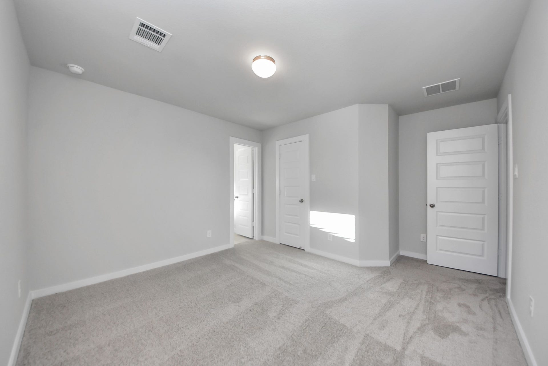 15111 Statice Trail, Houston, TX 77044 Secondary bedroom features plush carpeting, large windows that let in plenty of natural light, bright paint, and spacious closets.