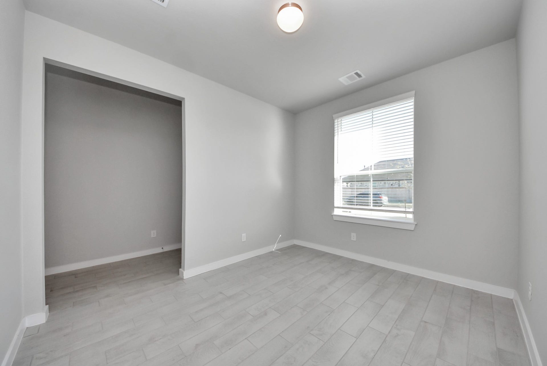 15111 Statice Trail, Houston, TX 77044 Experience the perfect blend of sophistication and warmth in this home office, boasting elegant wood-look tile flooring and flooded with natural light from expansive windows and French doors.