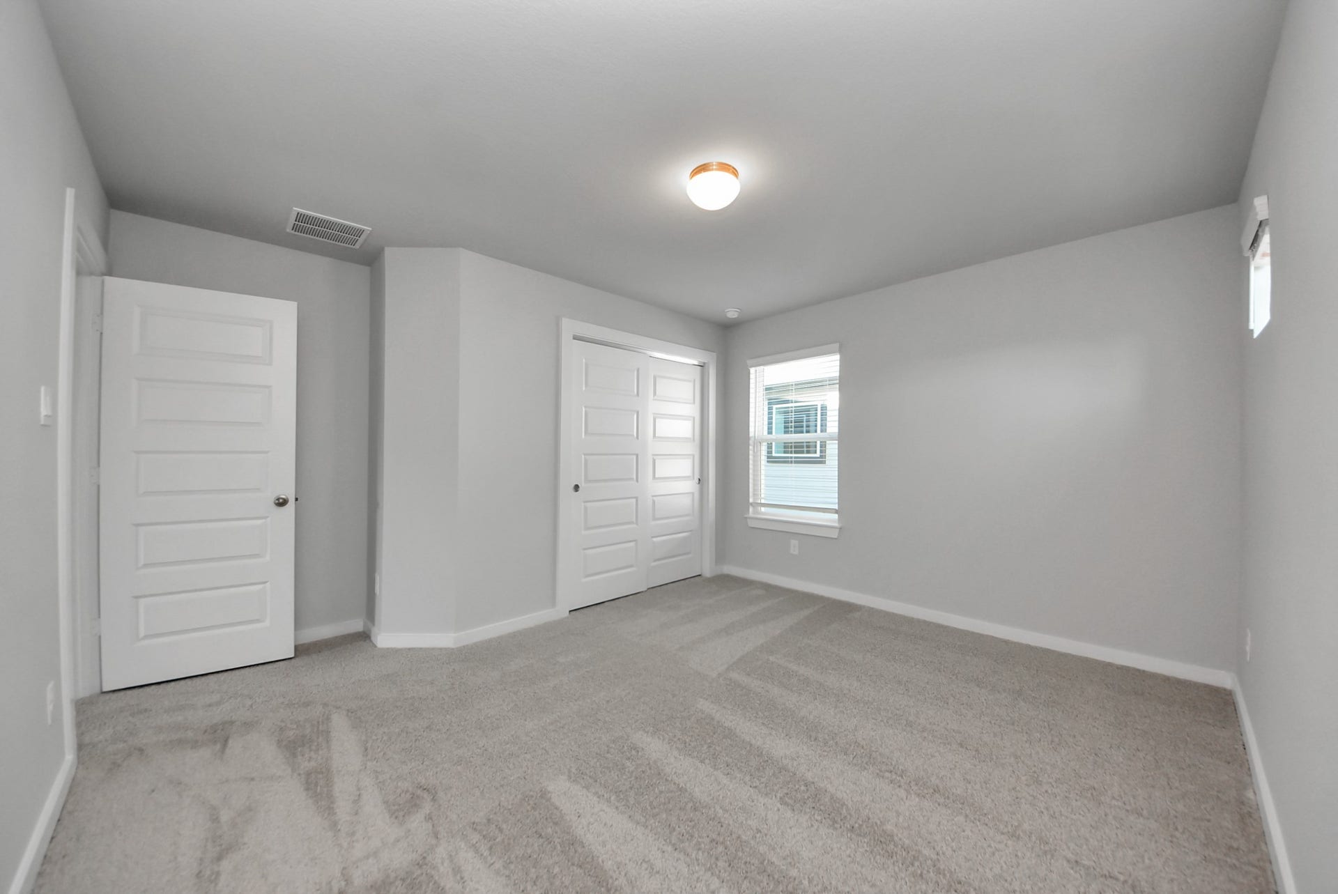 15111 Statice Trail, Houston, TX 77044 Generously sized secondary bedrooms featuring spacious closets, soft and inviting carpeting underfoot, large windows allowing plenty of natural light, and the added touch of privacy blinds for your personal retreat.