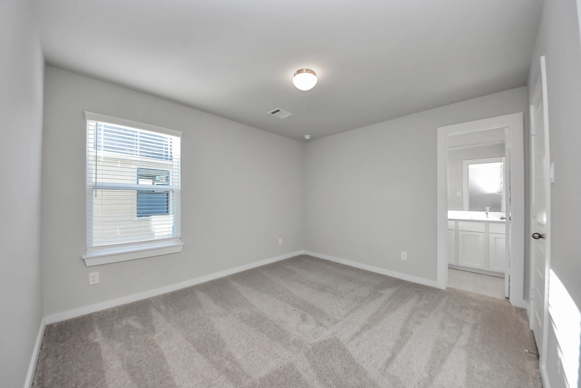 15111 Statice Trail, Houston, TX 77044 Generously sized secondary bedrooms featuring spacious closets, soft and inviting carpeting underfoot, large windows allowing plenty of natural light, and the added touch of privacy blinds for your personal retreat.
