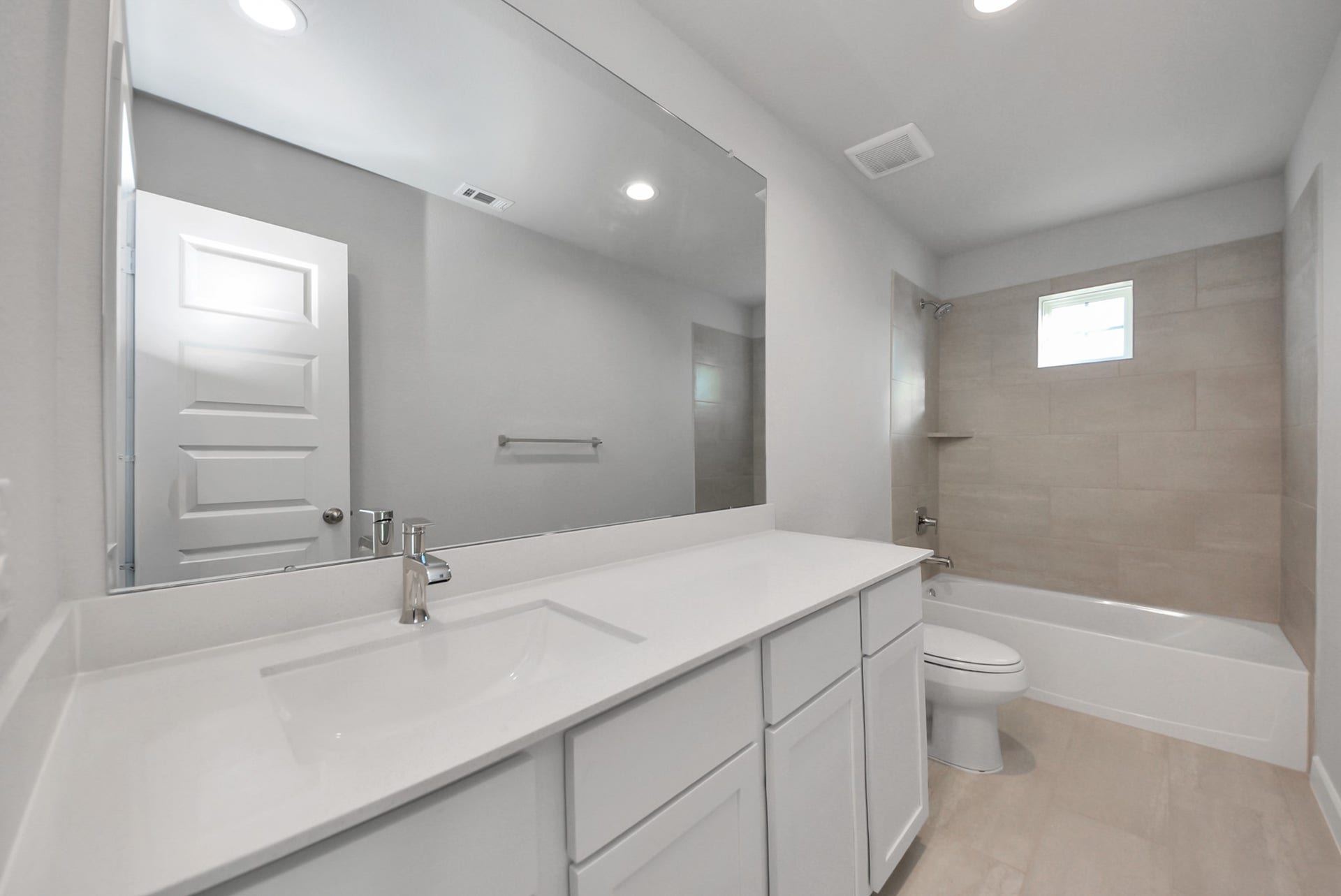 15111 Statice Trail, Houston, TX 77044 Secondary bath features tile flooring, bath/shower combo with tile surround, light stained wood cabinets, beautiful light countertop.
