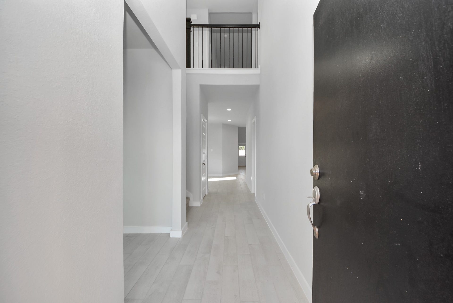 15111 Statice Trail, Houston, TX 77044 As you step into the threshold of this luxurious home, you'll soon be welcomed by an elegant glass door (to be installed). Inside, soaring ceilings amplify the spaciousness, while the refined wood-look tile flooring and oversized baseboards exude sophistication and charm.