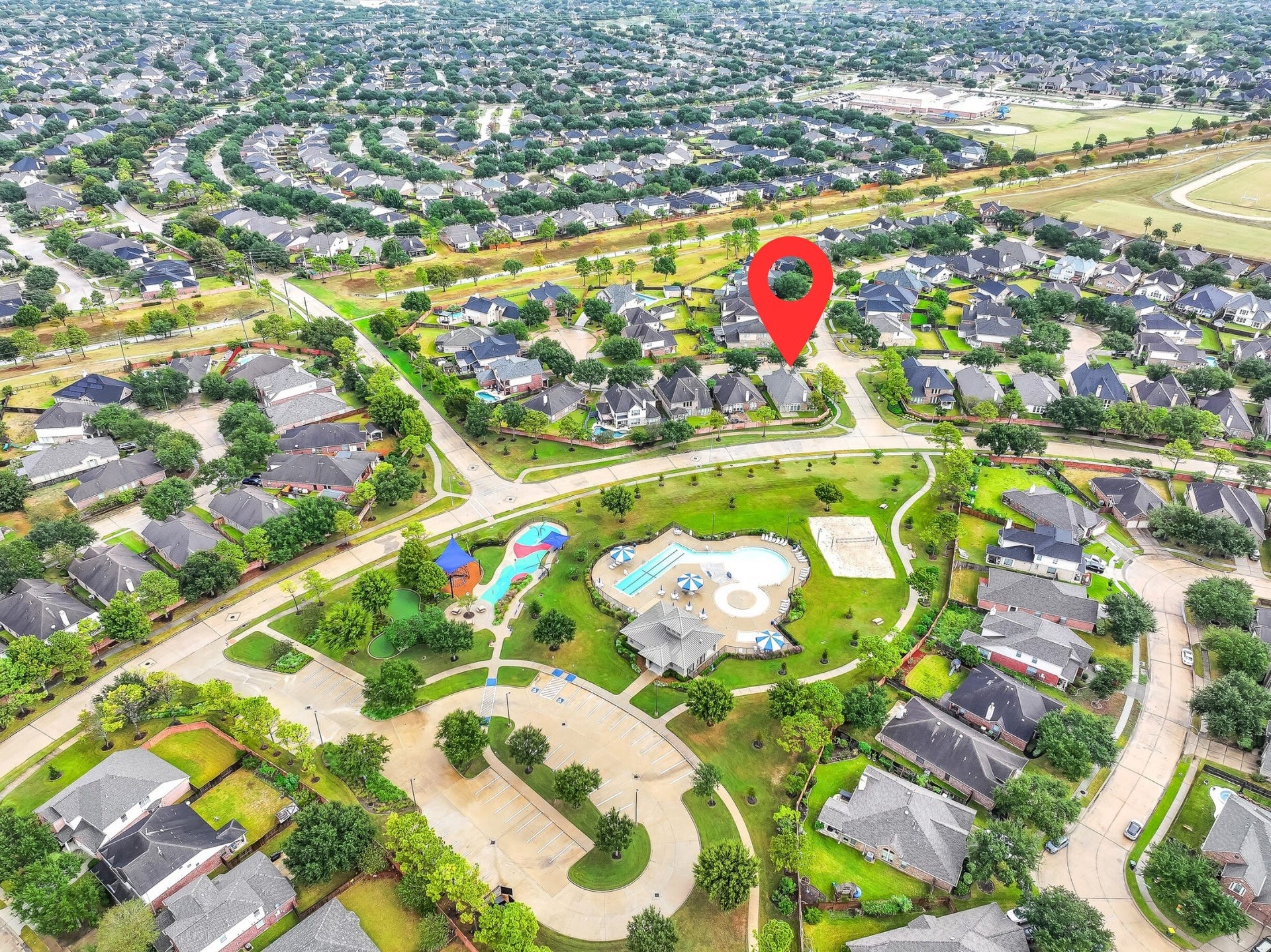 An incredible bird's-eye view highlights this home's location within Shadow Creek Ranch! The marked property sits on a corner lot along a cul-de-sac street, directly across from a beautifully maintained recreational area featuring a community pool, splash pad, open green space & winding walking paths.