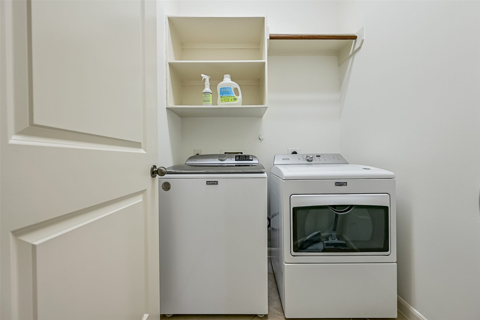 Conveniently located off the interior hallway, the utility room accommodates a full-size washer & dryer with open shelving above for laundry supplies. Additional hanging space provides extra functionality, while the home's thoughtful single-story layout keeps laundry duties close to the bedrooms.