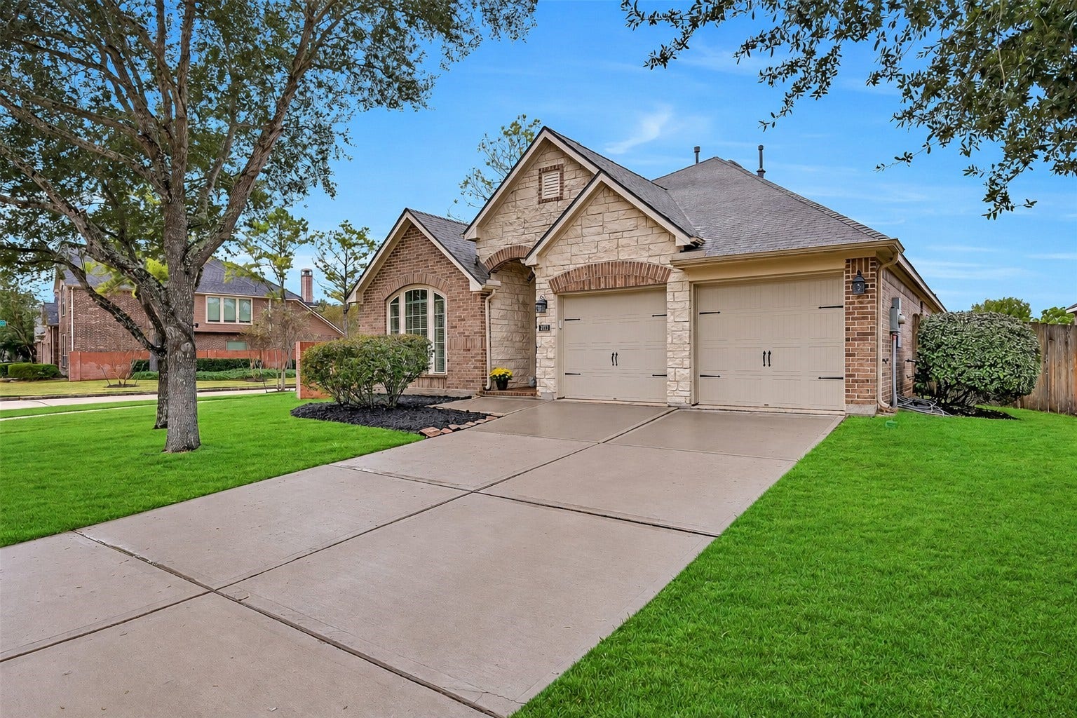 This inviting single-story Perry home showcases a handsome brick & stone exterior, multiple front-facing gables, mature shade trees & beautifully maintained landscaping. The corner lot provides an open setting, while the attached 2-car garage & wide driveway offer convenient parking.