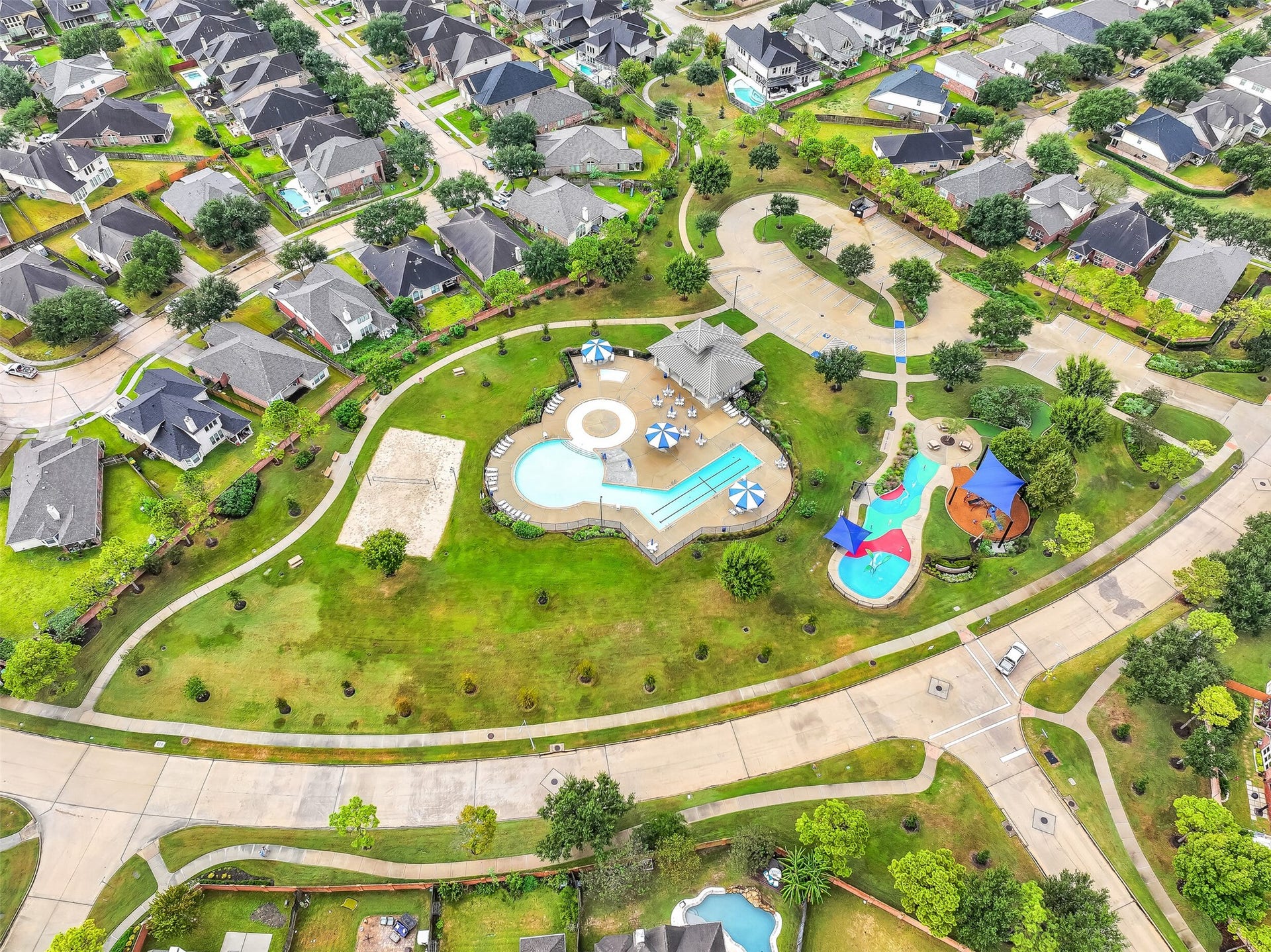 Take a closer look at the impressive neighborhood amenities located just across the street from 2818 Silhouette Bay! This beautifully landscaped recreational area features a resort-style swimming pool, colorful splash pad, beach volleyball court, shaded pavilion & winding sidewalks connecting the various outdoor spaces.