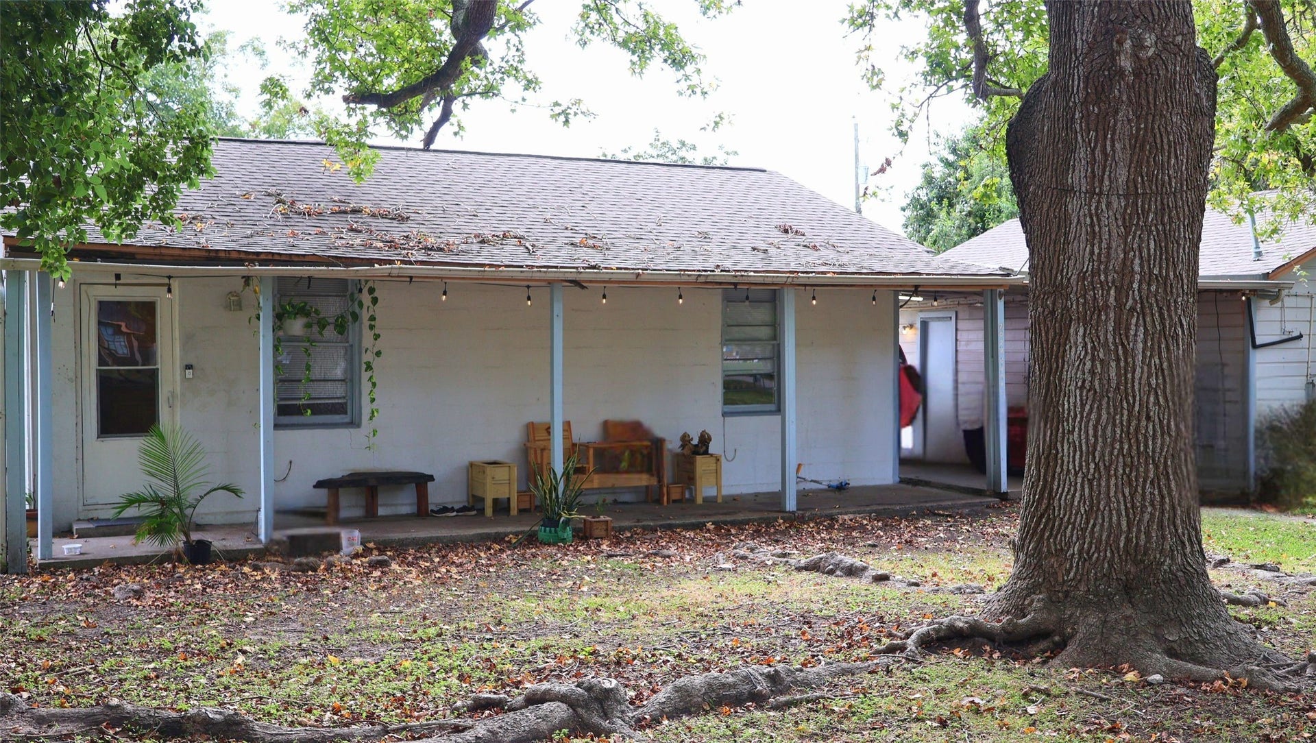 7029 Church Lane, Hitchcock, TX 77563 Charming single-story home with a cozy front porch, shaded by mature trees and perfect for relaxation.