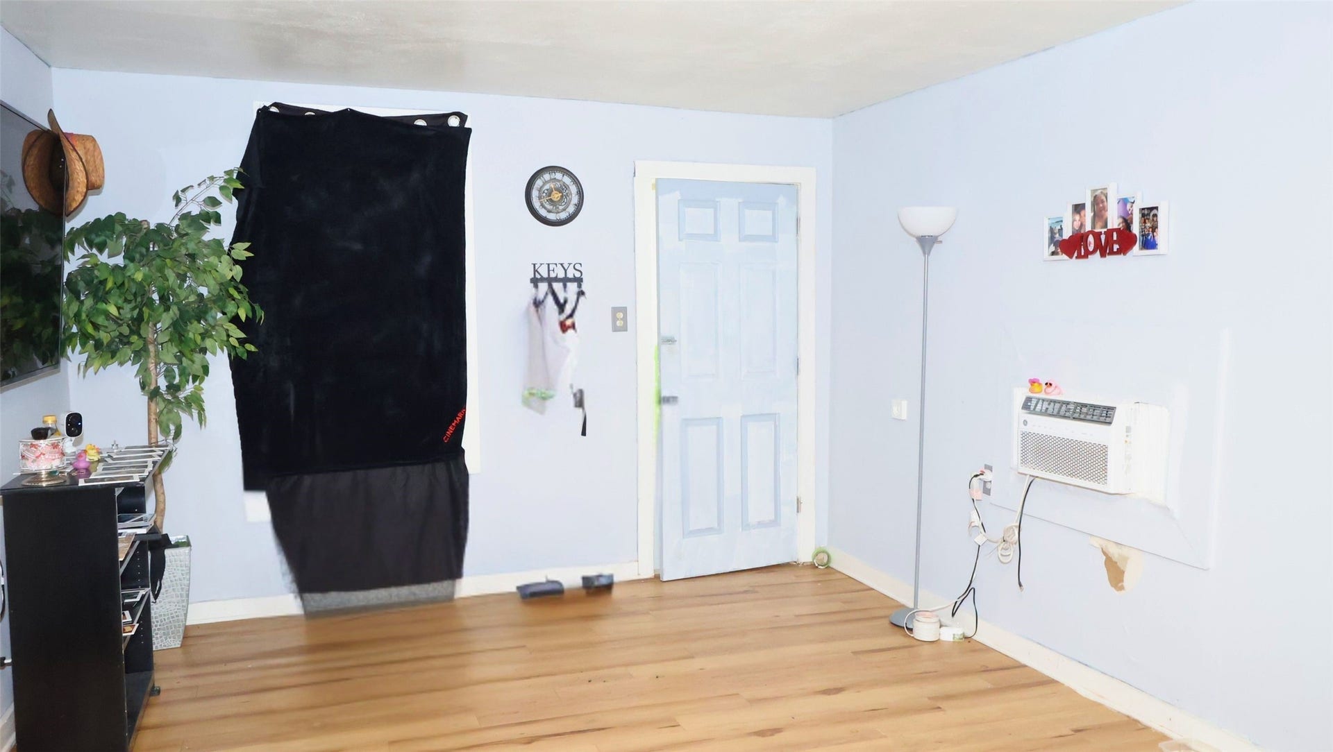 7029 Church Lane, Hitchcock, TX 77563 Bright and airy room with light blue walls, a wooden floor, and a wall-mounted air conditioner. Features charming, convenient storage solutions.