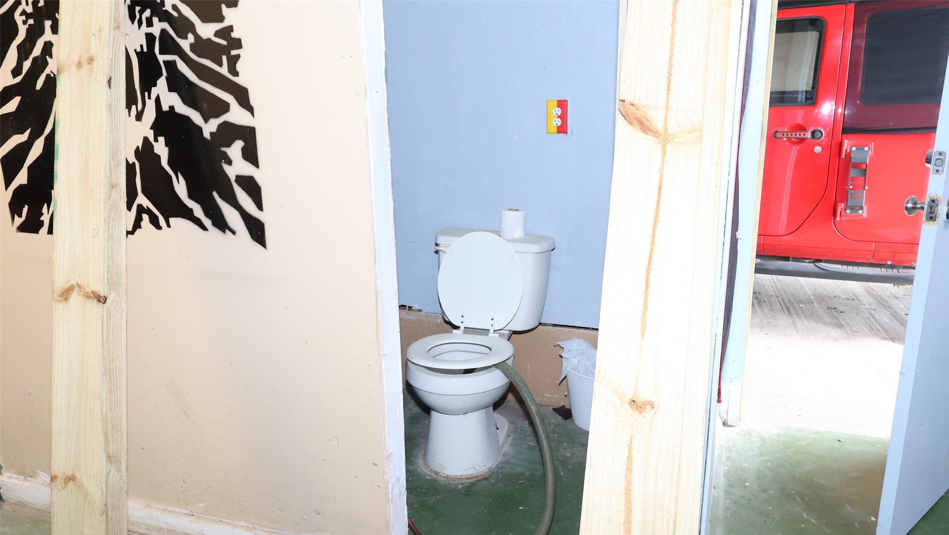 7029 Church Lane, Hitchcock, TX 77563 Compact bathroom space adjacent to a garage area.