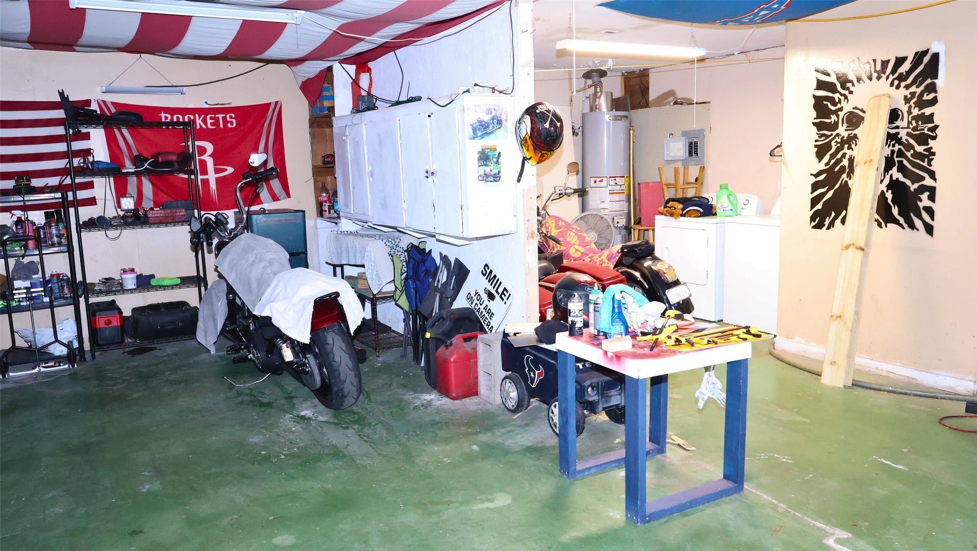 7029 Church Lane, Hitchcock, TX 77563 Spacious garage with ample storage, workbench, and utility area, perfect for hobbyists and DIY enthusiasts.