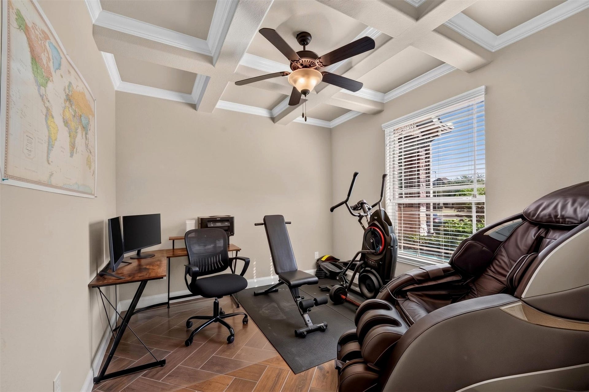27818 Burchfield Grove Lane, Katy, TX 77494 A versatile room provides space for a home office, workout equipment, or a combination of both. The coffered ceiling with crown molding adds architectural interest, while a large window brings in natural light.