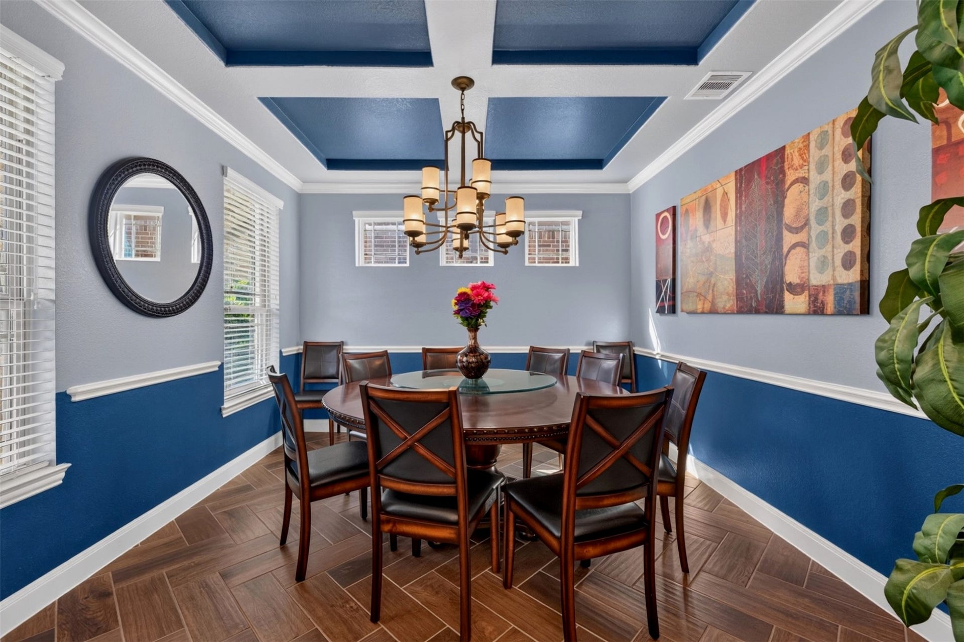 27818 Burchfield Grove Lane, Katy, TX 77494 The ormal dining room, to the left of the entry, is designed to make gatherings feel special. The dramatic tray ceiling with contrasting blue inset, elegant chandelier, crown molding, and herringbone-pattern wood-look tile create a distinctive setting for holiday dinners and celebrations.