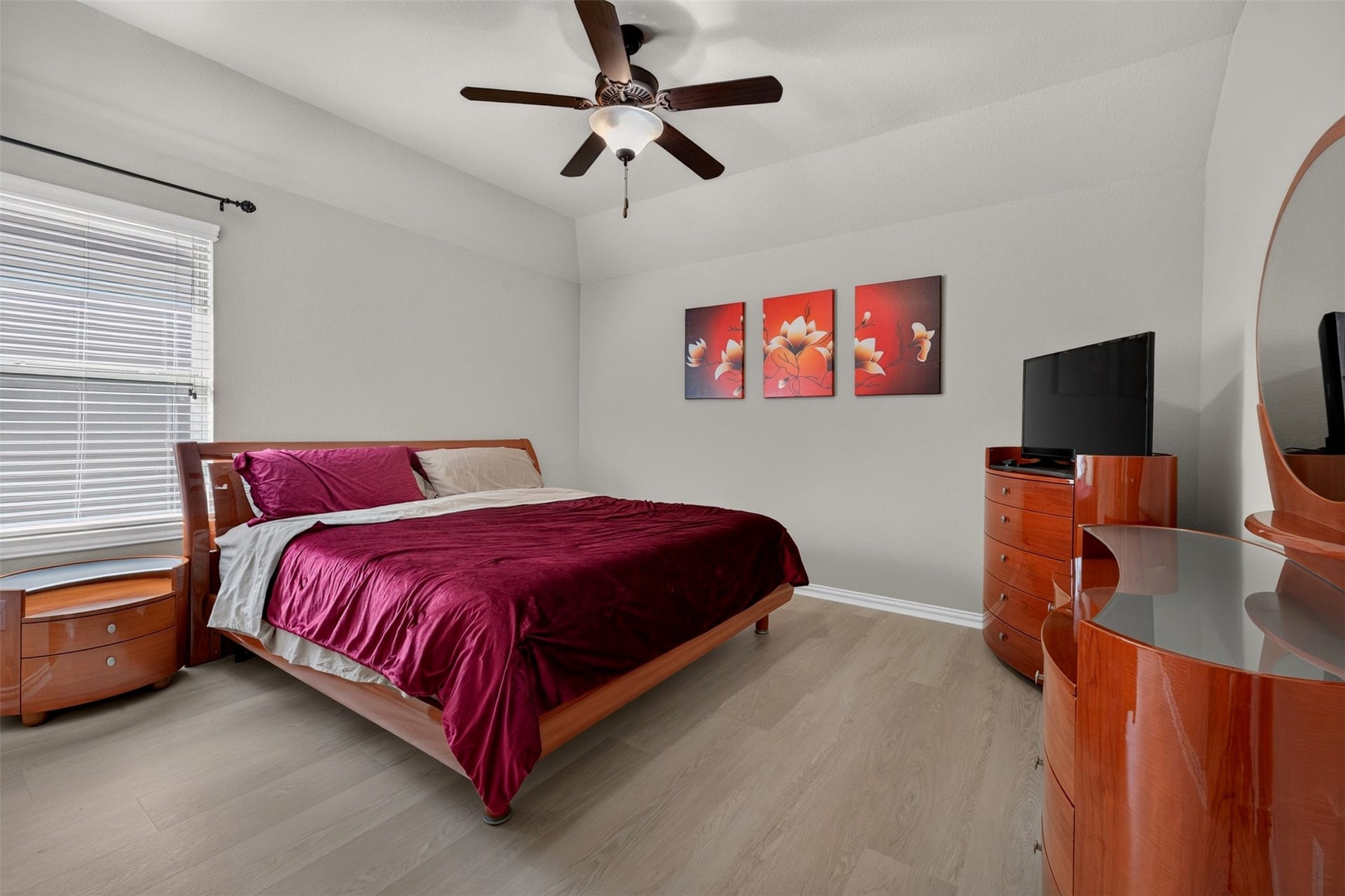 27818 Burchfield Grove Lane, Katy, TX 77494 Warm wood furnishings complement the neutral finishes in this inviting bedroom. A ceiling fan, and a generous window reate a comfortable retreat for relaxing at the end of the day.