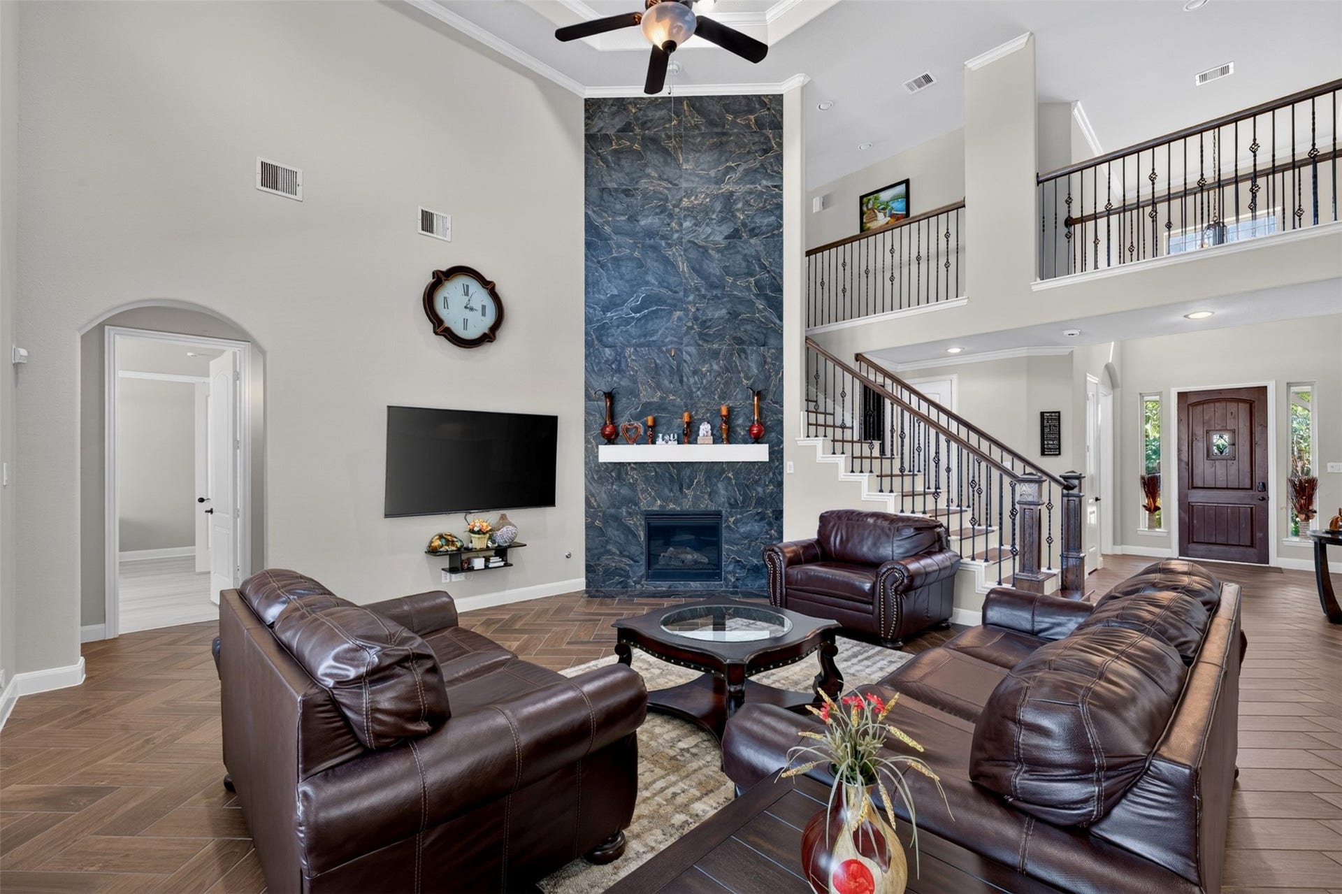 27818 Burchfield Grove Lane, Katy, TX 77494 A striking cast stone fireplace creates a beautiful focal point, adding character and visual interest to the space. The elevated ceiling enhances the home's open, airy feel.
