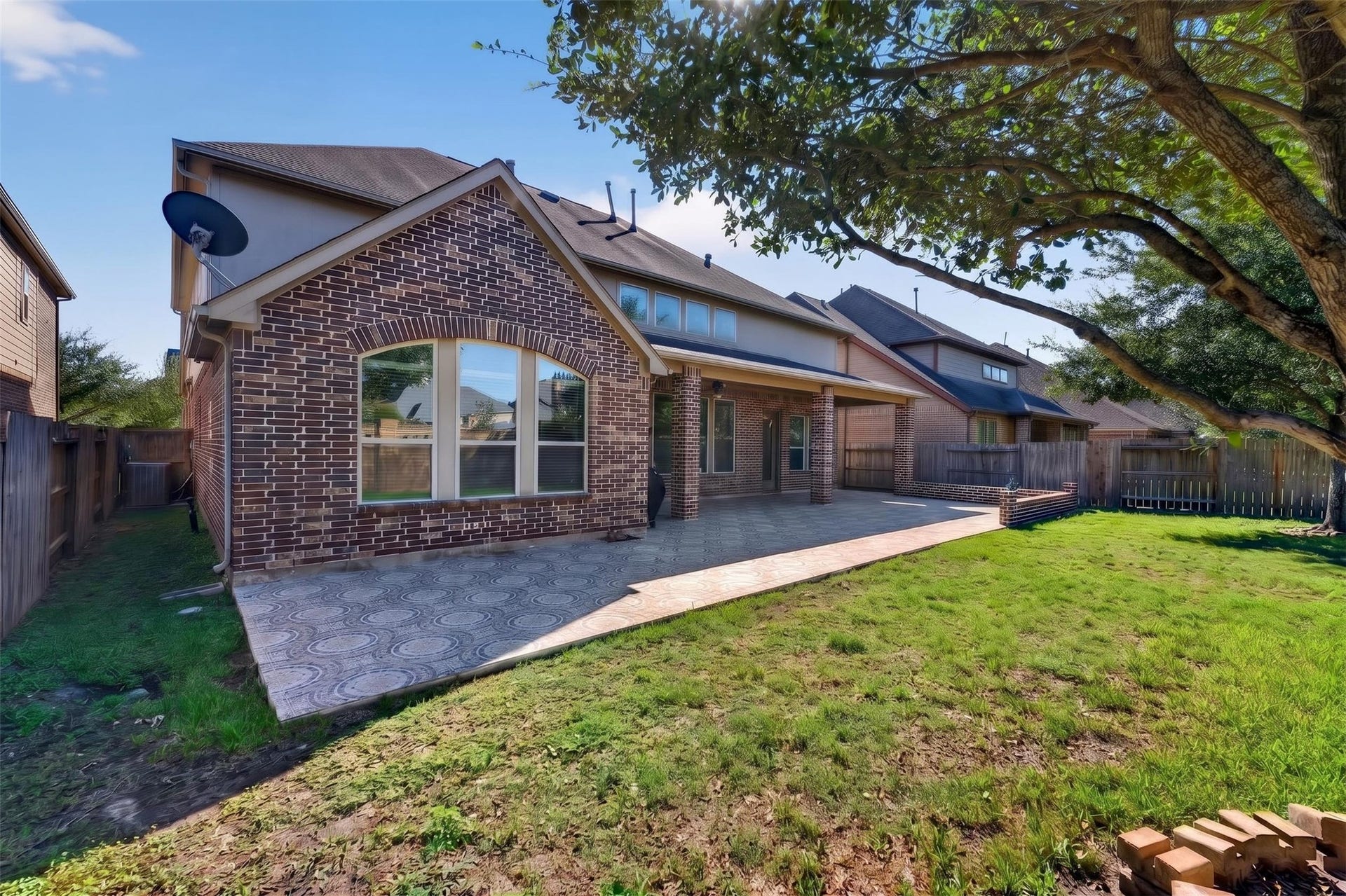 27818 Burchfield Grove Lane, Katy, TX 77494 Enjoy another perspective of the outdoor space, highlighting the broad patio and grassy yard.