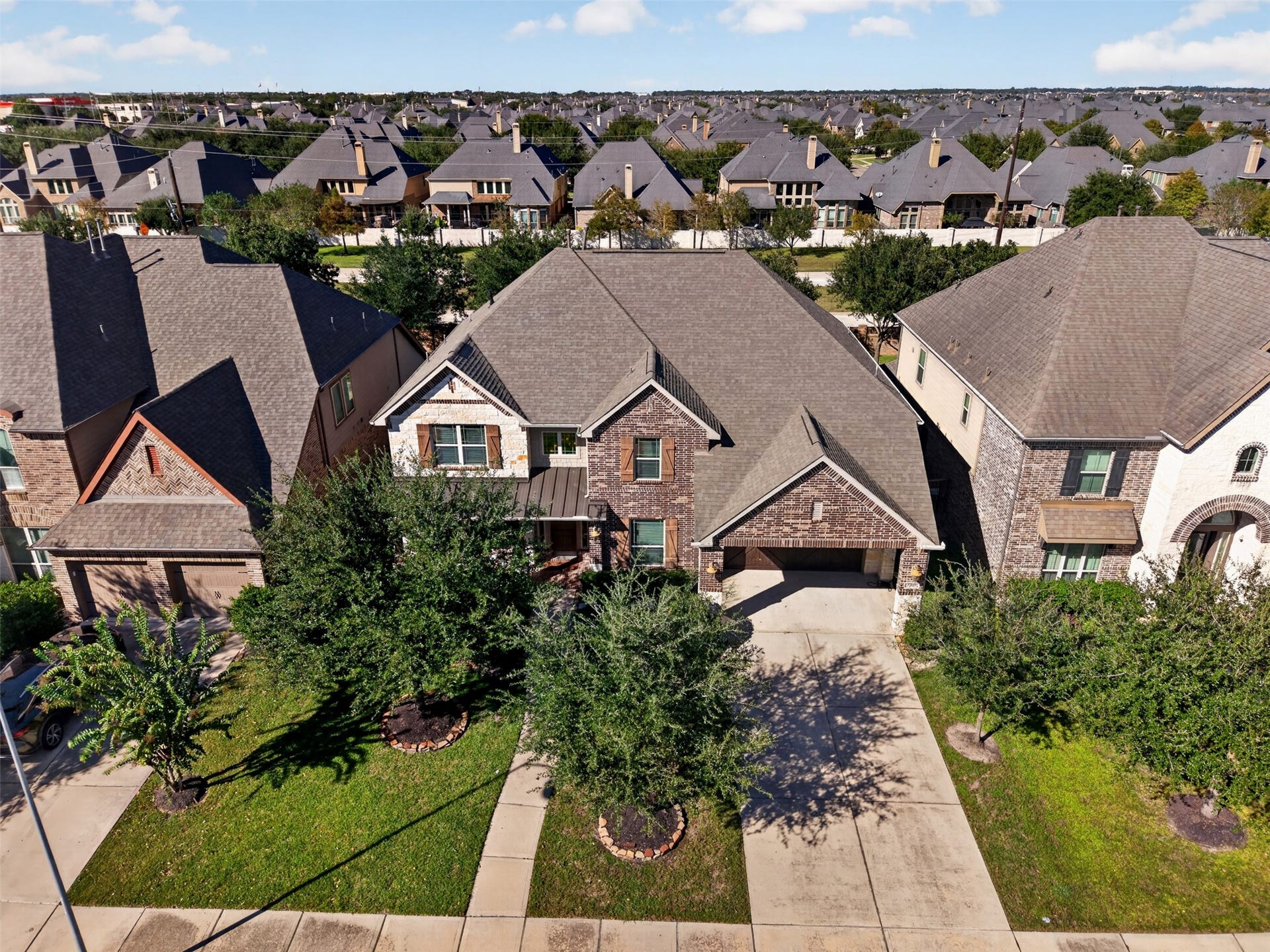 27818 Burchfield Grove Lane, Katy, TX 77494 From above, appreciate the home's impressive rooflines, attractive exterior, and beautifully maintained front lawn. The established neighborhood setting adds to the appeal.