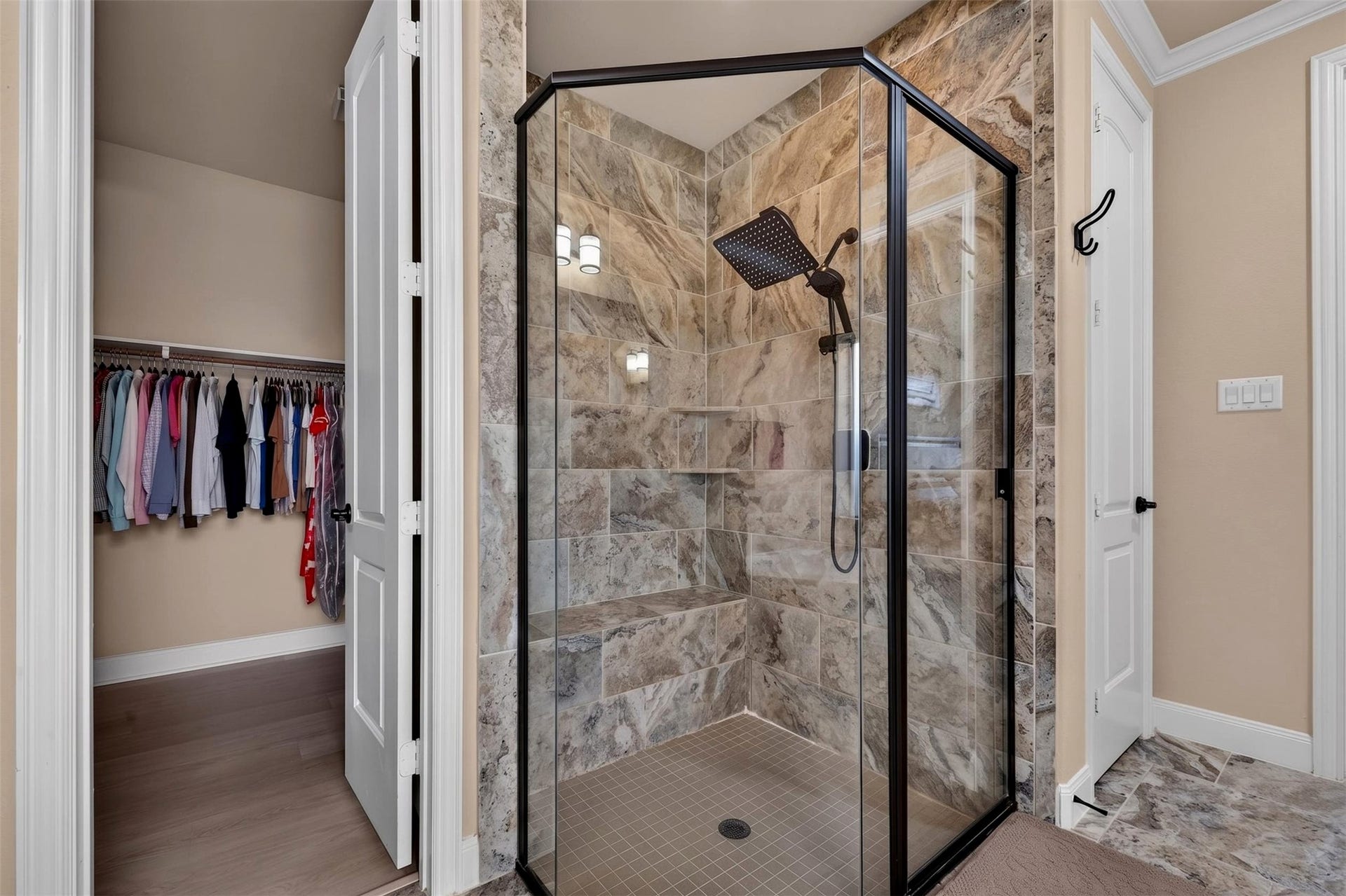 27818 Burchfield Grove Lane, Katy, TX 77494 The oversized walk-in shower features floor-to-ceiling stone-look tile, a clear glass enclosure, and a built-in bench for added comfort. A rainfall-style showerhead and recessed niches bring both convenience and a spa-inspired feel to the design.